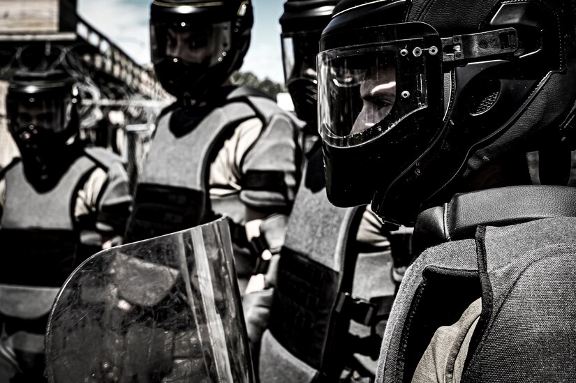 U.S. Army National Guard Soldiers assigned to the 340th Military Police company don crowd control gear to simulate the in-processing of a detainee as part of a simulated exercise on Joint Base McGuire-Dix Lakehurst, N.J., July 30, 2022. Soldiers from the 333rd MP Brigade, 340th MP Battalion gathered here for Gotham Justice, a four-week exercise that trained, challenged and improved Soldiers’ primary skill sets and core MP competencies required in detention operations and security and mobility support operations. (U.S. Air Force photo by Senior Airman Matt Porter)