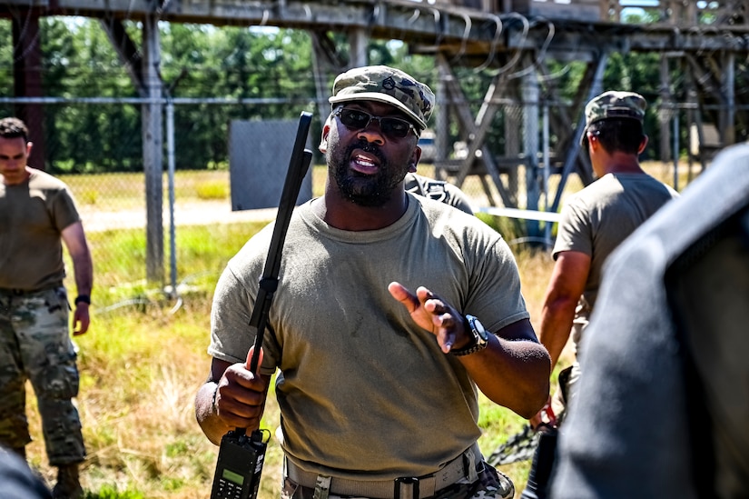 A U.S. Army National Guard Soldier assigned to the 340th Military Police company provides feedback as part of a simulated exercise on Joint Base McGuire-Dix Lakehurst, N.J., July 30, 2022. Soldiers from the 333rd MP Brigade, 340th MP Battalion gathered here for Gotham Justice, a four-week exercise that trained, challenged and improved Soldiers’ primary skill sets and core MP competencies required in detention operations and security and mobility support operations. (U.S. Air Force photo by Senior Airman Matt Porter)