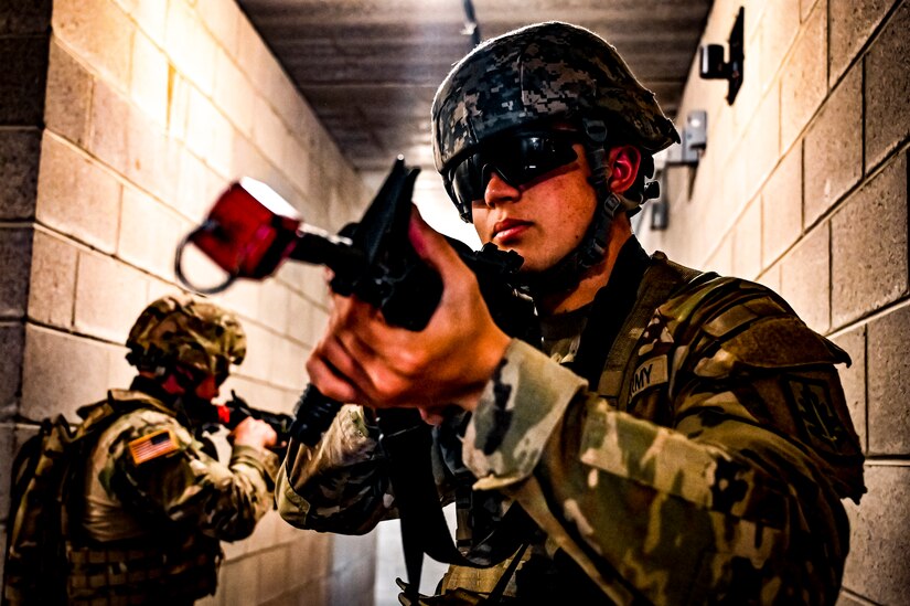 A U.S. Army National Guard Soldier assigned to the 333rd Military Police Brigade performs a STX lane as part of a simulated exercise on Joint Base McGuire-Dix Lakehurst, N.J., July 31, 2022. Soldiers from the 333rd MP Brigade, 340th MP Battalion gathered here for Gotham Justice, a four-week exercise that trained, challenged and improved Soldiers’ primary skill sets and core MP competencies required in detention operations and security and mobility support operations. (U.S. Air Force photo by Senior Airman Matt Porter)