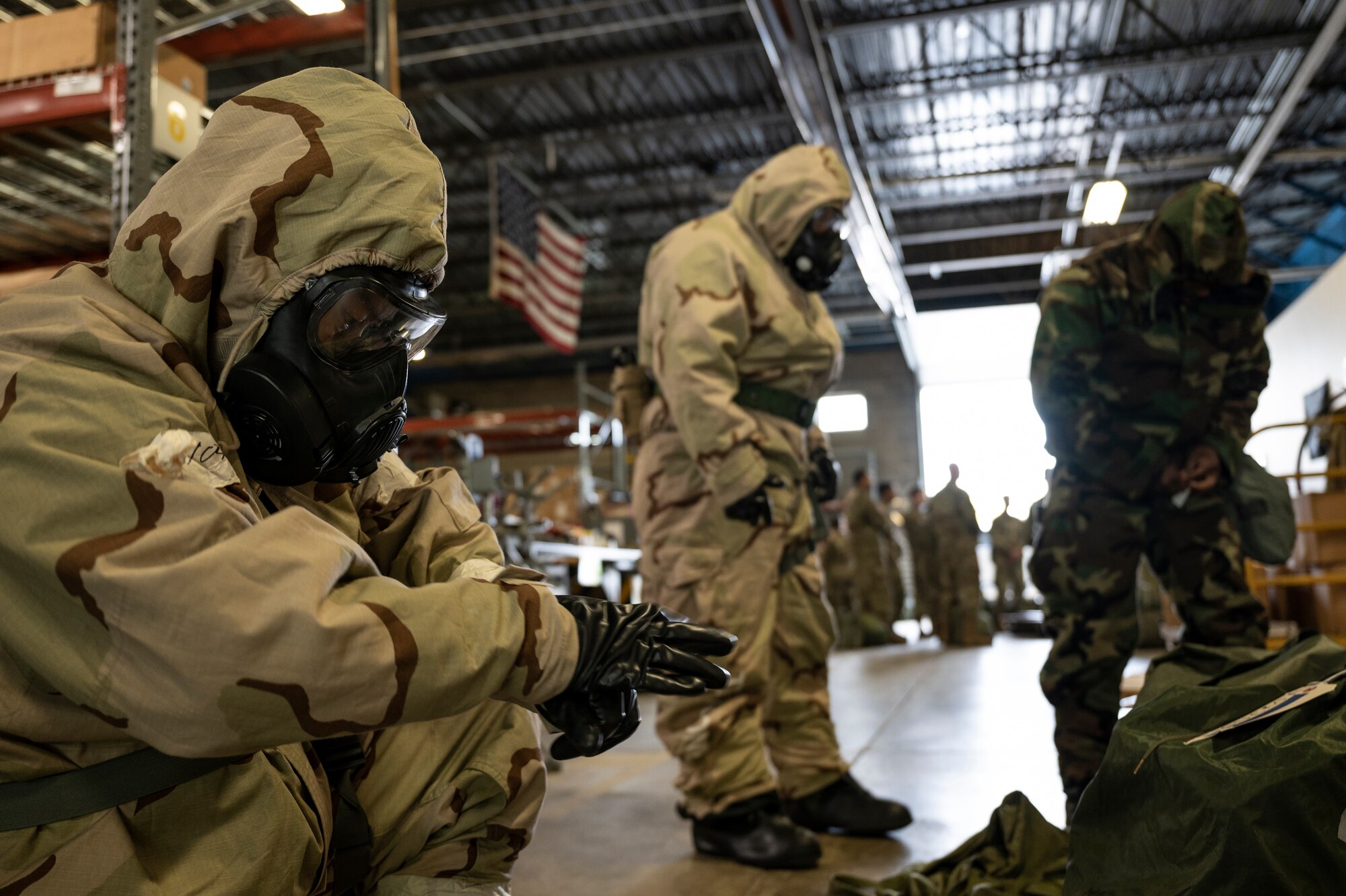 Airmen assigned to the 911th Logistics Readiness Squadron don mission-oriented protective posture gear at the Pittsburgh International Airport Air Reserve Station, Pennsylvania, May 7, 2022.