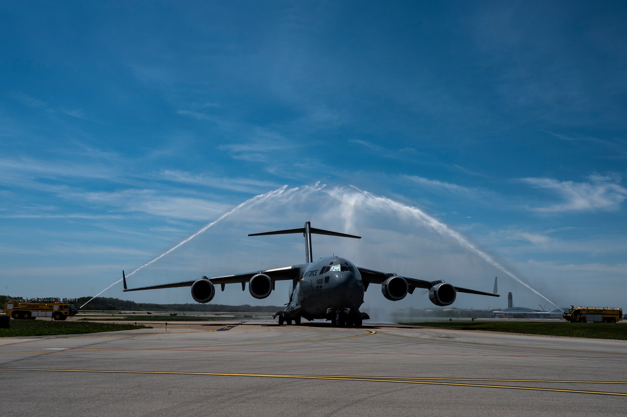 Col. John F. Robinson, 911th Airlift Wing commander, pilots a C-17 Globemaster III as it is sprayed by Allegheny County Airport Authority firetrucks while it taxis back to the Pittsburgh International Airport Air Reserve Station, Pennsylvania, May 10, 2022.