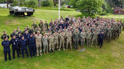 Personnel representing various global military units supporting Exercise Baltic Operations 2022 (BALTOPS 22) pause at the Ravlunda site during National Day of Sweden, June 6. The Naval Surface Warfare Center Panama City Division (NSWC PCD) Integrated Mine Countermeasures Tactics team provided the combined task group staff with support during the exercise and brought that experience back to the Navy lab. BALTOPS, which began in 1975, is the premier maritime-focused annual exercise that takes place in the Baltic Region and demonstrates partnership, security and preserving regional peace. (courtesy photo)