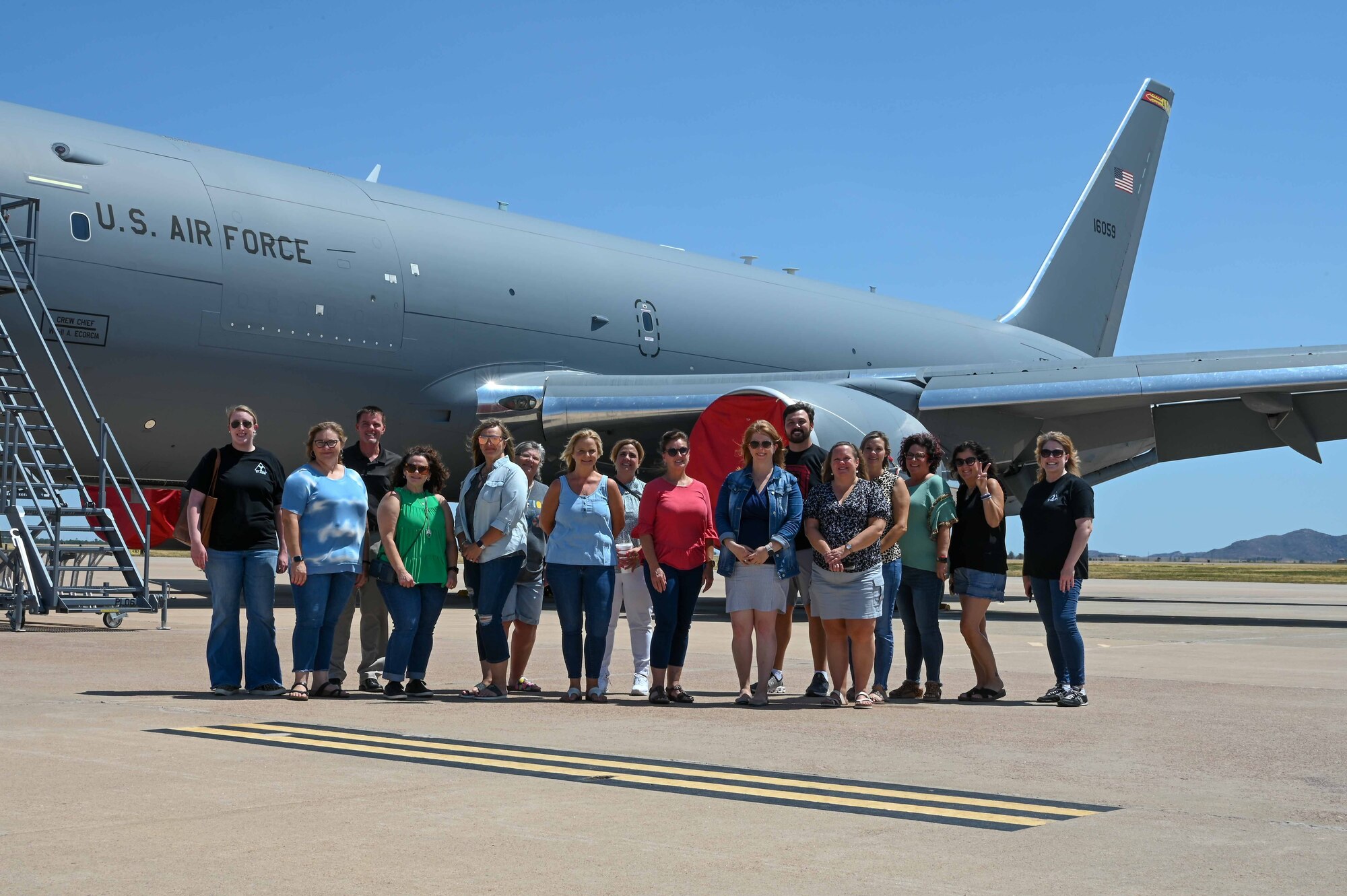 Local teachers and Airmen from Altus Air Force Base (AAFB), Oklahoma, pose in front of a KC-46 Pegasus, Aug. 2, 2022. Teachers witnessed airpower generated from AAFB by watching aircraft taxi and takeoff. (U.S. Air Force photo Senior Airman Kayla Christenson)