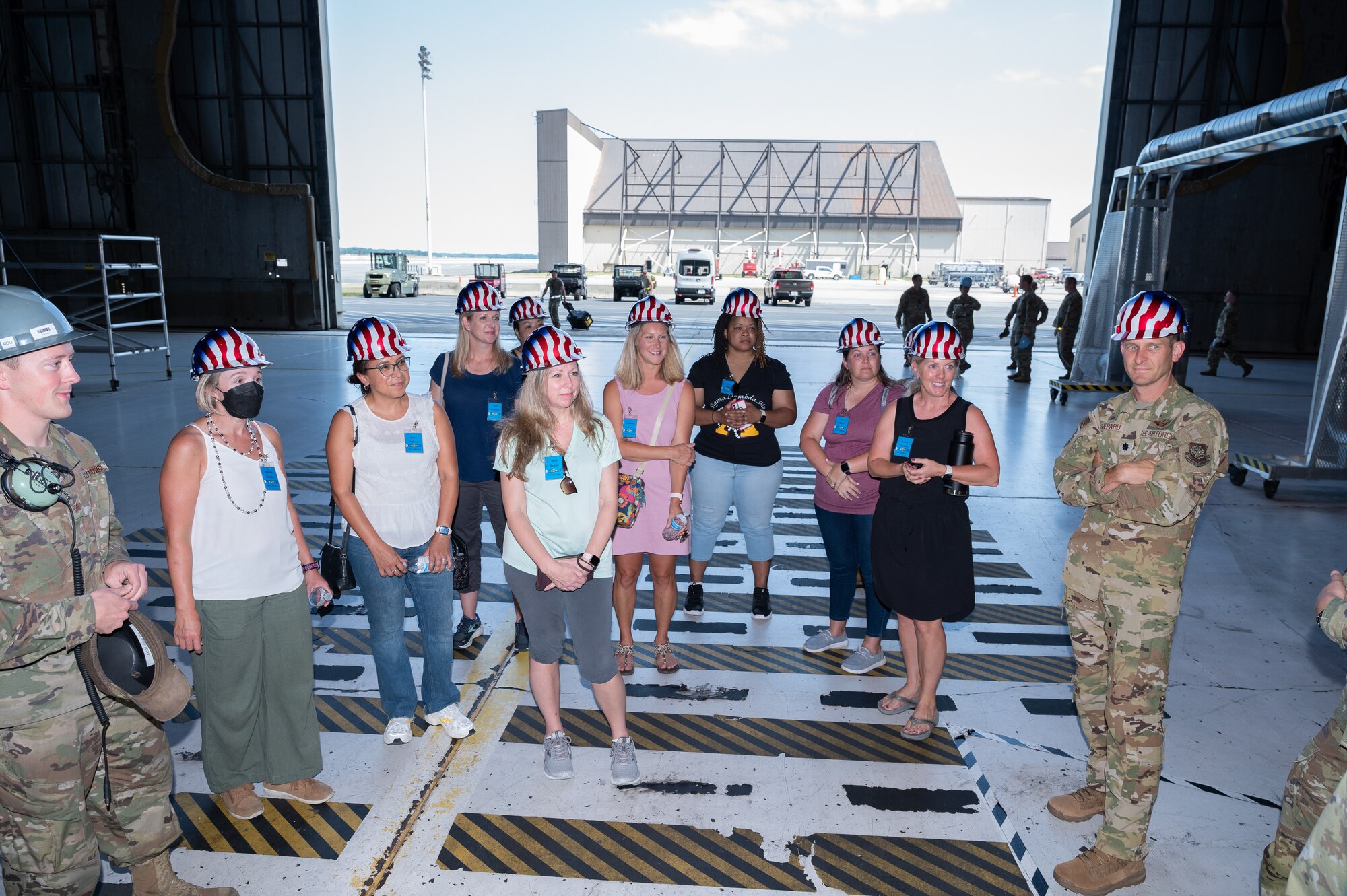 Spouses of Dover Air Force Base commanders and senior enlisted leaders visit the Isochronal Inspection Dock during a spouse immersion tour on Dover AFB, Delaware, Aug. 3, 2022. Sixteen spouses toured the base and met with Airmen from various squadrons to familiarize themselves with the Team Dover mission. (U.S. Air Force photo by Mauricio Campino)