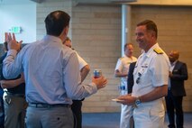 Rear Adm. Mark Sucato, commander, Navy Region Northwest, mingles with other attendees during a reception at City Hall during Fleet Week, Aug. 3, 2022. Fleet Week Seattle is a time-honored celebration of the sea services and provides an opportunity for the citizens of Washington to meet Sailors, Marines and Coast Guardsmen, as well as witness firsthand the latest capabilities of today's maritime services. (U.S. Navy photo by Mass Communication Specialist 2nd Class Victoria Galbraith)