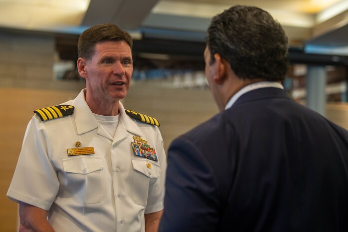 Capt. Steve Foley, commanding officer, USS Lake Champlain (CG 57), mingles with Seattle Mayor Bruce Harrell, during a reception at City Hall during Fleet Week, Aug. 3, 2022. Fleet Week Seattle is a time-honored celebration of the sea services and provides an opportunity for the citizens of Washington to meet Sailors, Marines and Coast Guardsmen, as well as witness firsthand the latest capabilities of today's maritime services. (U.S. Navy photo by Mass Communication Specialist 2nd Class Victoria Galbraith)