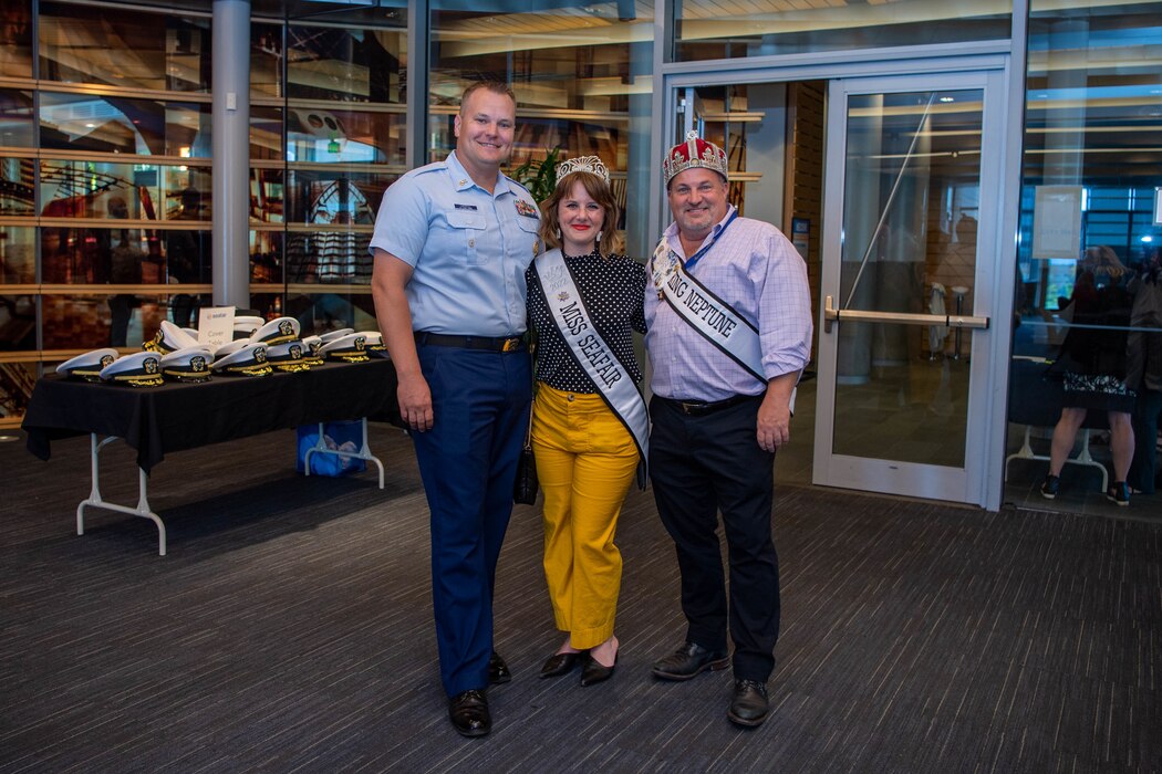 Miss Seafair and King Neptune pose for a photo with a Coast Guardsman during a reception at City Hall during Fleet Week, Aug. 3, 2022. Fleet Week Seattle is a time-honored celebration of the sea services and provides an opportunity for the citizens of Washington to meet Sailors, Marines and Coast Guardsmen, as well as witness firsthand the latest capabilities of today's maritime services. (U.S. Navy photo by Mass Communication Specialist 2nd Class Victoria Galbraith)