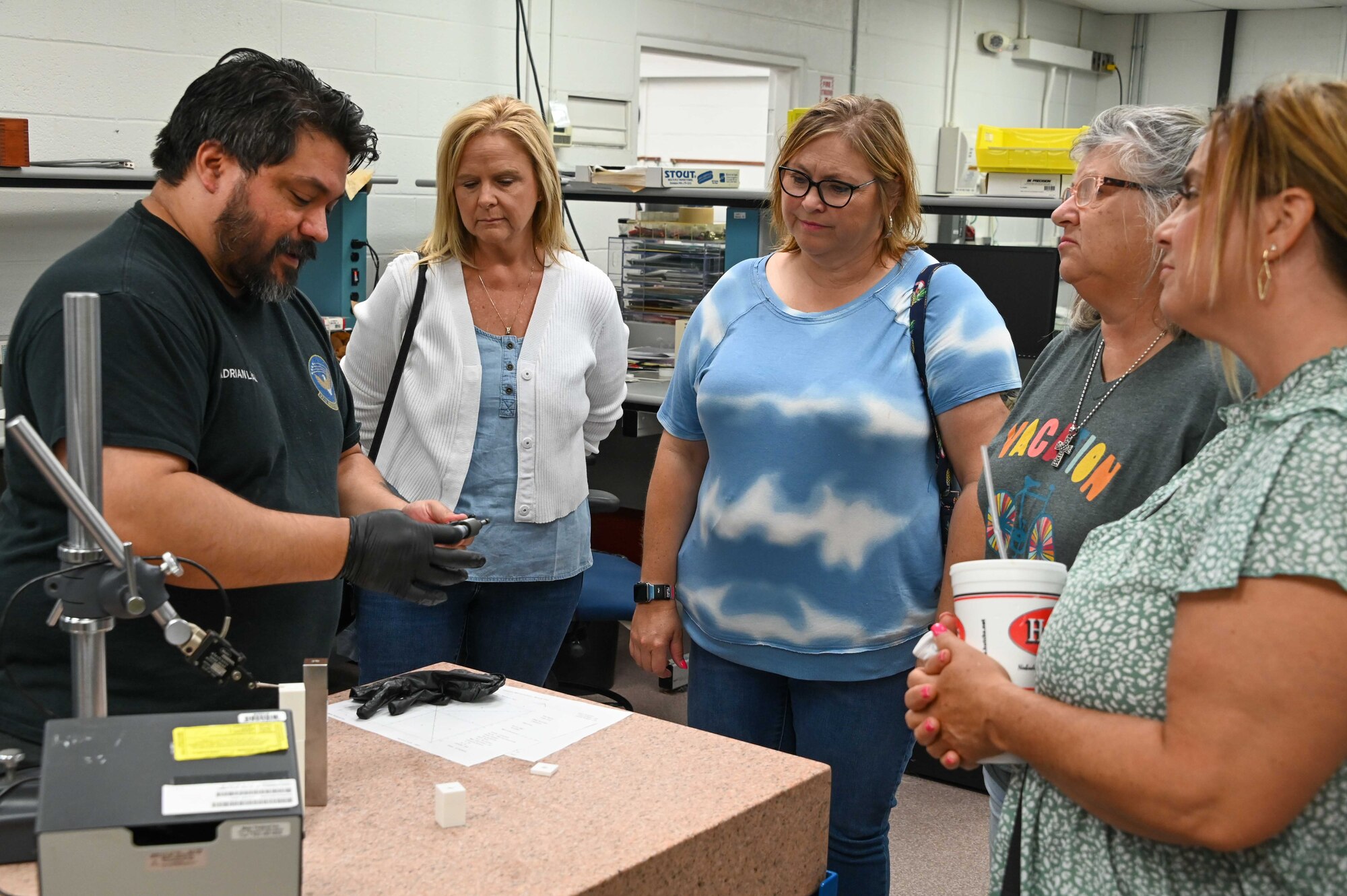 Adrian Leal, 97th Maintenance Squadron Precision Management Equipment Laboratory (PMEL) technician, performs a demonstration for local teachers at Altus Air Force Base (AAFB), Oklahoma, Aug. 2, 2022. The teachers stopped at the PMEL to learn more about the science, technology, engineering, and mathematics aspect of AAFB. (U.S. Air Force photo Senior Airman Kayla Christenson)