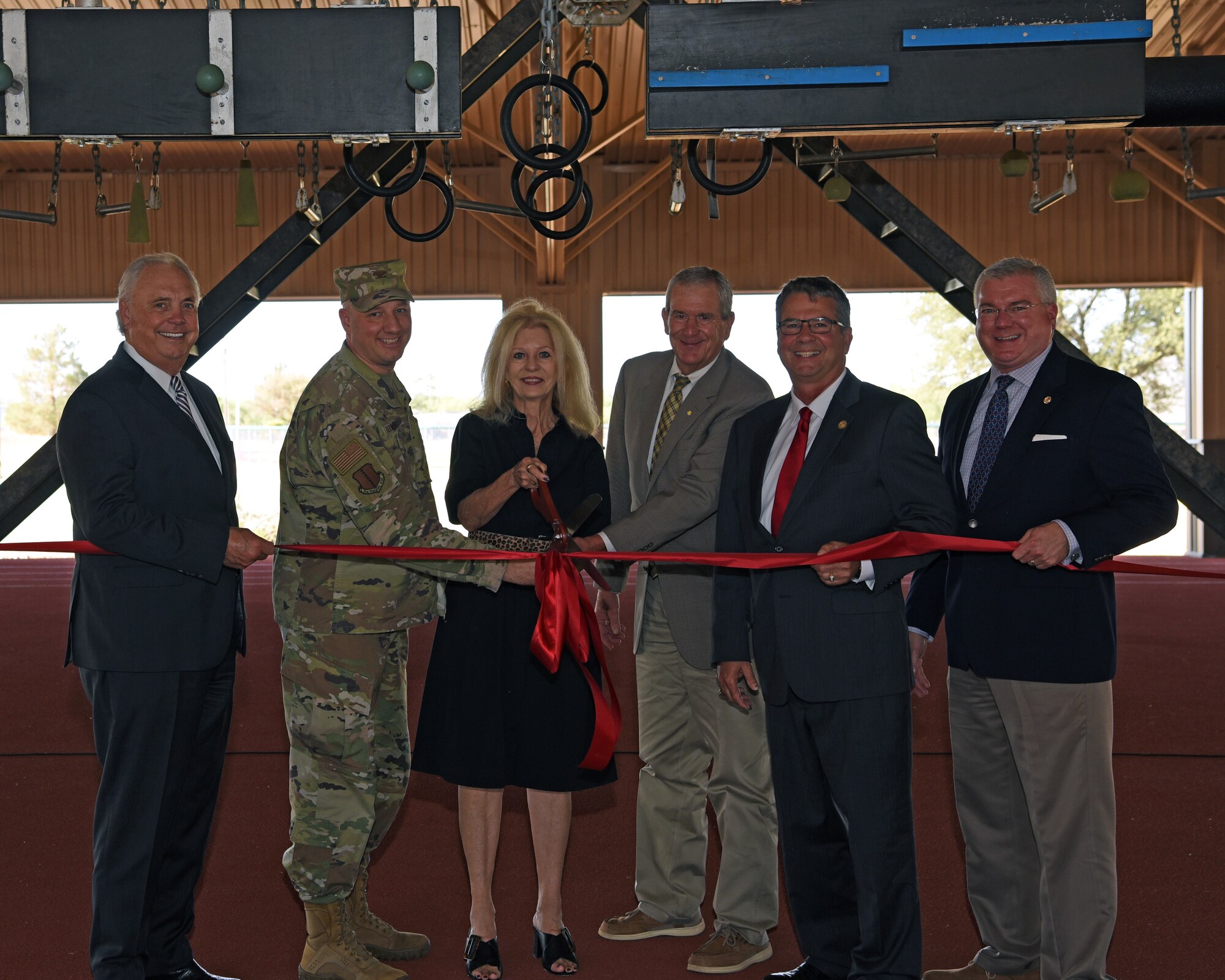 From left to right:   Representative Drew Darby, Texas House Member, House District 72;
U.S. Air Force Col. Matthew Reilman, 17th Training Wing commander; City of San Angelo Mayor, Brenda Gunter; Judge Stephen Floyd, Tom Green Country Judge; Senator Charles Perry, 
Texas State Senate, District 28; and Keith Graf, executive director, Texas Military Preparedness Commission, cut a ribbon at the opening of a new outdoor covered Alpha warrior pad, Goodfellow Air Force Base, Texas, Aug. 3, 2022. The updated pad was paid for by a Defense Economic Adjustment Assistance Grant awarded by the state of Texas. (U.S. Air Force photo by Senior Airman Abbey Rieves)