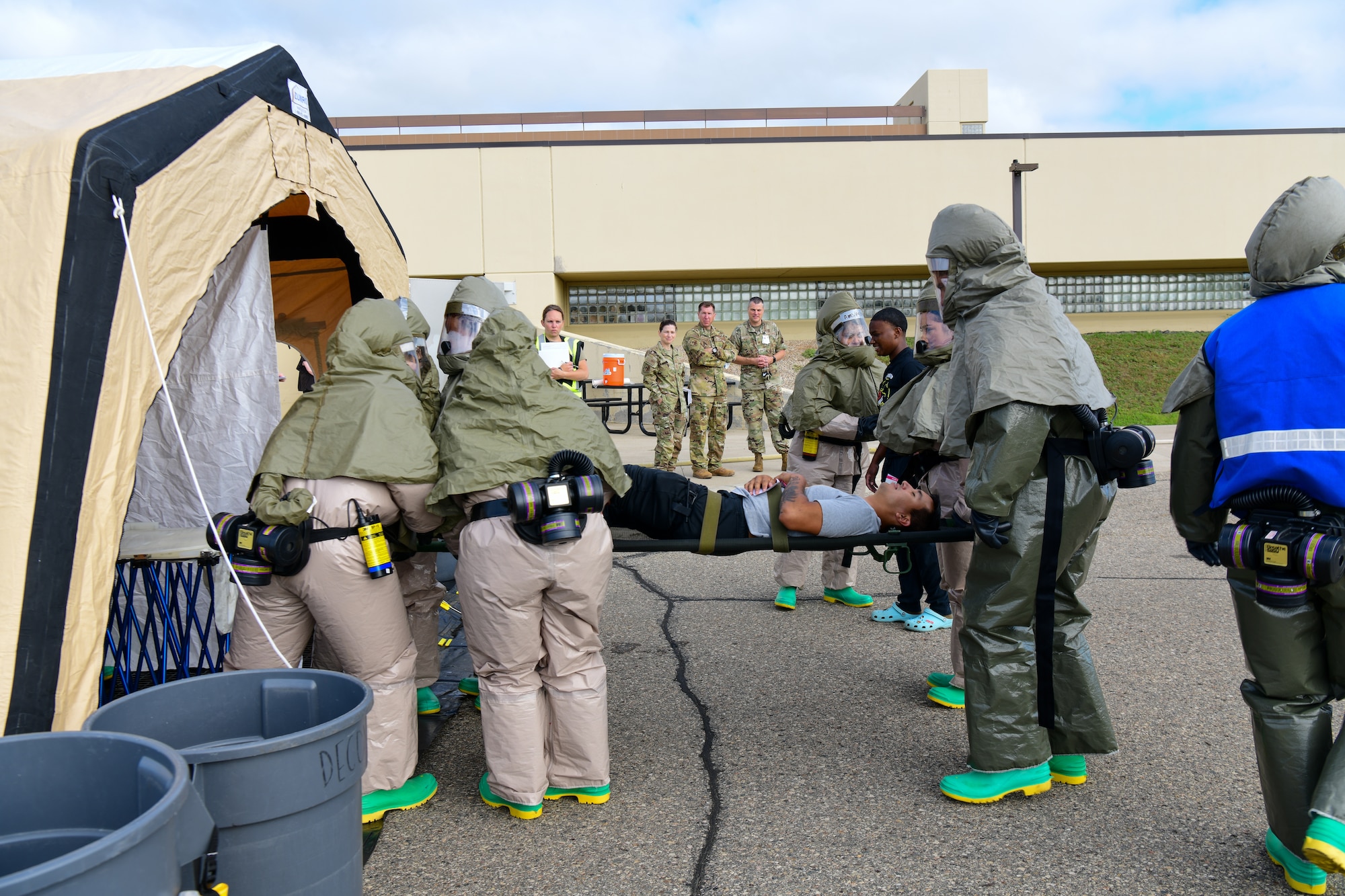 Airmen from the 5th Medical Group wraps a compression bandage around a simulated leg injury during exercise Ready Eagle in the 5th MDG building on Minot Air Force Base Aug. 3, 2022. The exercise allowed Airmen to train and practice Tactical Combat Casualty Care (TCCC), the decontamination process (DCON), and operating in high-tempo situations to prepare them for possible future incidents. (U.S. Air Force photo by Airmen Alysa Knott)