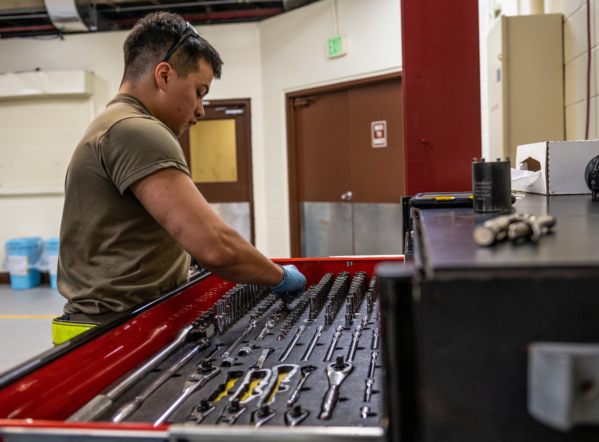 Airman looking for tools in a tool chest
