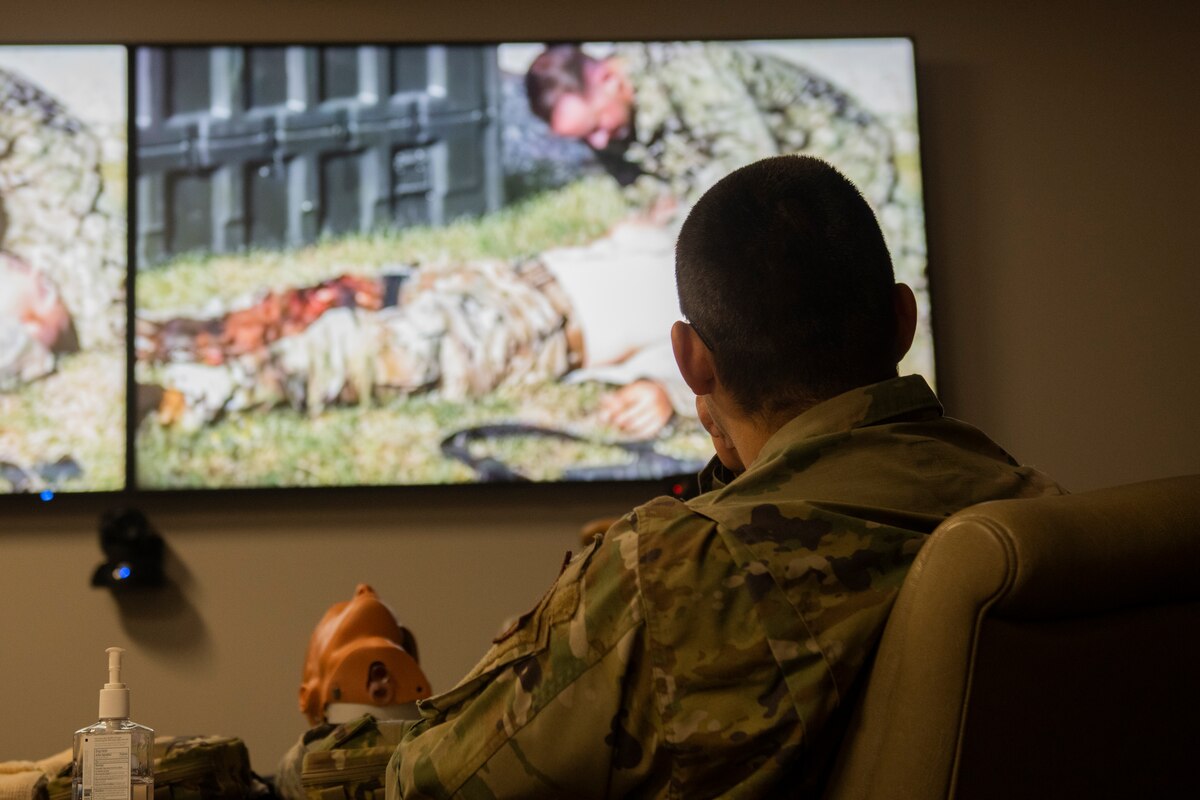 U.S. Air Force Staff Sgt. Alan Garcia, 325th Fighter Wing command post emergency management controller, watches a Tactical Combat Casualty Care training video at Tyndall Air Force Base, Florida, July 21, 2022. The Committee on Tactical Combat Casualty Care utilizes data and real-world expertise to develop the best practices to be used for medical response in a battlefield environment. (U.S. Air Force photo by Staff Sgt. Cheyenne Lewis)
