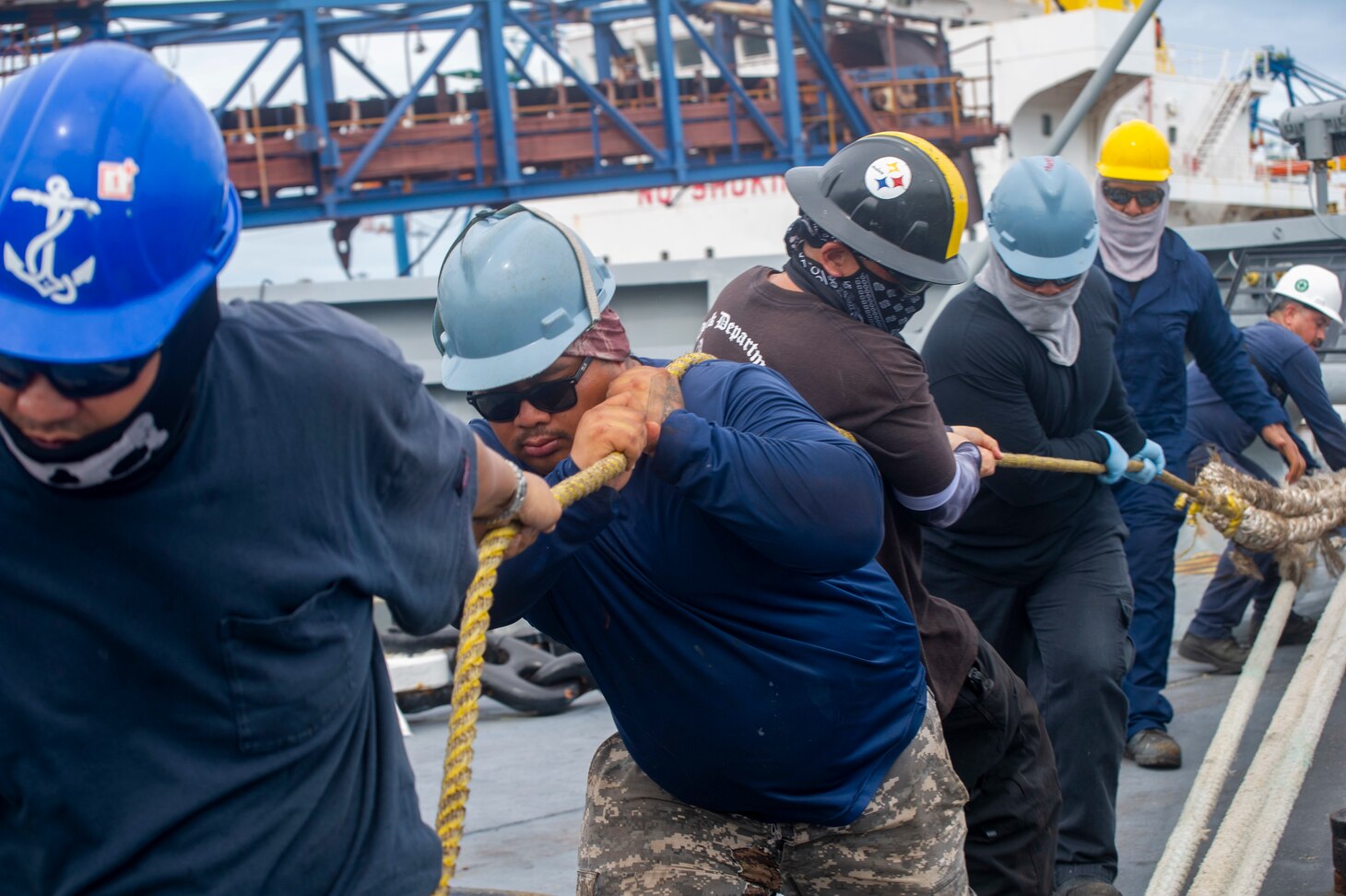 VISAKHAPATNAM, India (Aug. 4, 2022) – Military Sealift Command civil service mariners assigned to the Emory S. Land-class submarine tender USS Frank Cable (AS 40) heave a line as the ship prepares to depart Visakhapatnam, India, Aug. 4, 2022. Frank Cable is currently on patrol conducting expeditionary maintenance and logistics in the 7th Fleet area of operations in support of a free and open Indo-Pacific. (U.S. Navy photo by Mass Communication Specialist 3rd Class Wendy Arauz)