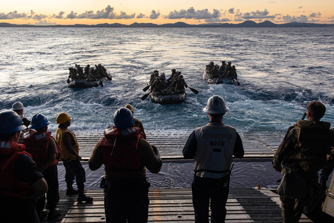 U.S. Marines with Battalion Landing Team 2/5, 31st Marine Expeditionary Unit, paddle out during a boat raid debarkation aboard USS New Orleans in the Philippine Sea, Aug. 2, 2022. The 31st MEU is operating aboard the ships of the Tripoli Expeditionary Strike Group in the 7th fleet area of operations to enhance interoperability with allies and partners and serve as a ready response force to defend peace and stability in the Indo-Pacific Region.