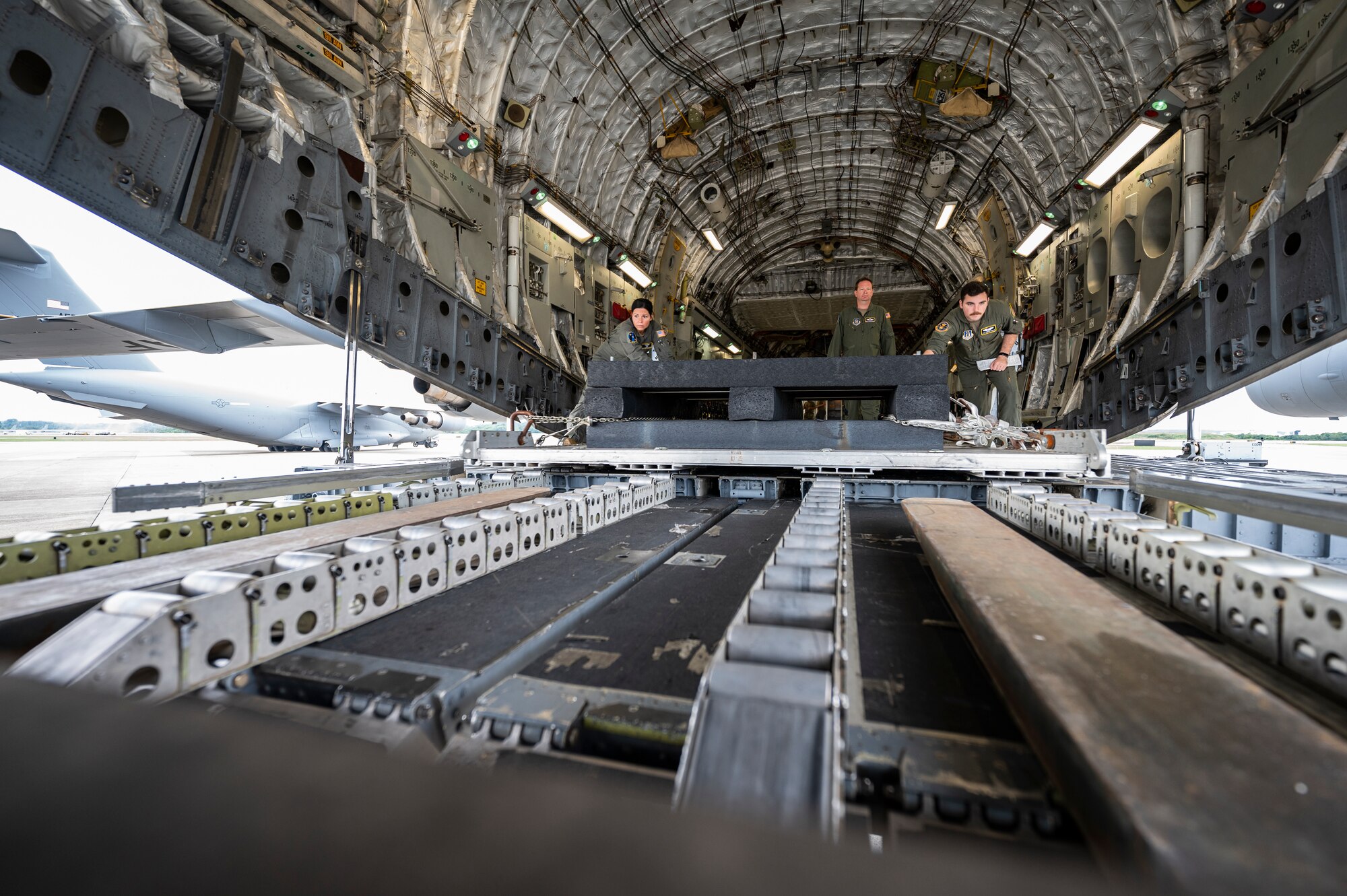 Loadmasters assigned to the 758th Airlift Squadron, move a pallet toward a forklift while conducting upgrade training at the Pittsburgh International Airport Air Reserve Station, Pennsylvania, July 29, 2022.
