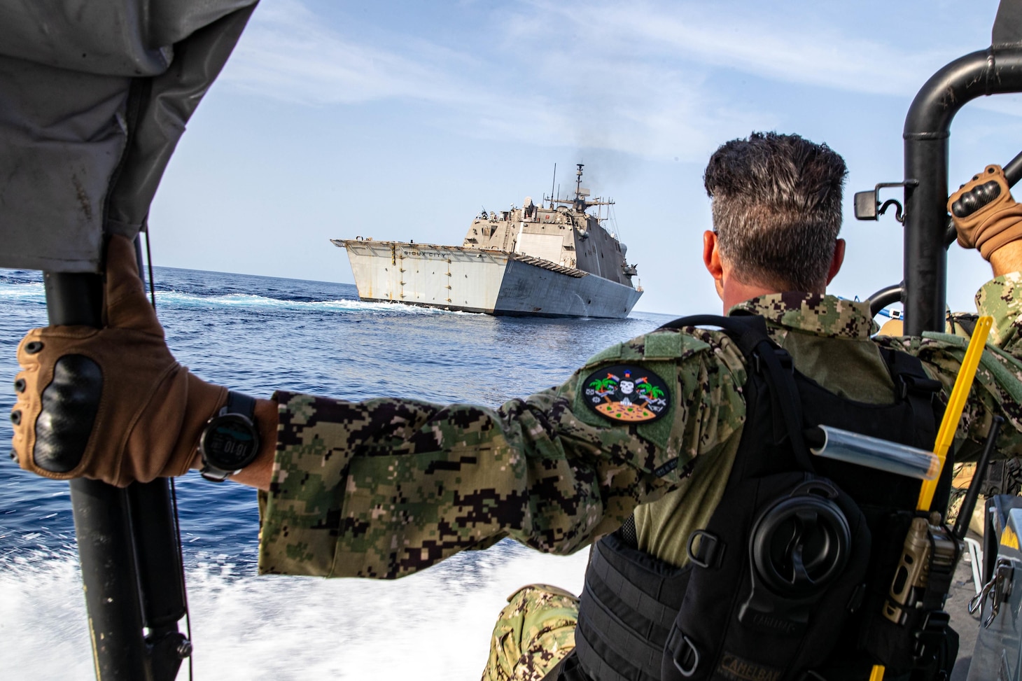 GULF OF ADEN (June 7, 2022) Senior Chief Fire Controlman David Yanvary approaches the littoral combat ship USS Sioux City (LCS 11) while participating in visit board search and seizure (VBSS) training aboard a rigid-hull inflatable boat in the Gulf of Aden, June 7. Sioux City is deployed to the U.S. 5th Fleet area of operations to help ensure maritime security and stability in the Middle East region. (U.S. Navy photo by Mass Communication Specialist 3rd Class Nicholas A. Russell)