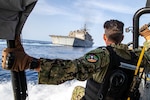 GULF OF ADEN (June 7, 2022) Senior Chief Fire Controlman David Yanvary approaches the littoral combat ship USS Sioux City (LCS 11) while participating in visit board search and seizure (VBSS) training aboard a rigid-hull inflatable boat in the Gulf of Aden, June 7. Sioux City is deployed to the U.S. 5th Fleet area of operations to help ensure maritime security and stability in the Middle East region. (U.S. Navy photo by Mass Communication Specialist 3rd Class Nicholas A. Russell)