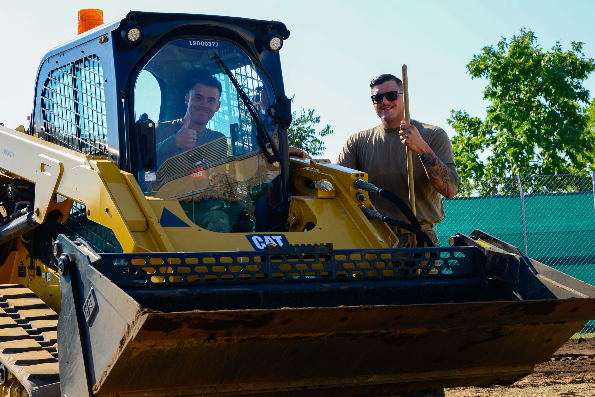 U.S. Air Force Staff Sgt. Joshua Carney, 31st Civil Engineer Squadron pavements and heavy equipment journeyman, and Senior Airman Jacob Bates, 31st CES pavements and heavy equipment journeyman, operate a bulldozer at Aviano Air Base, Italy, July 20, 2022. As members of the 31st CES’s “Dirt Boyz” section, Carney and Bates are responsible for any CE project that involves construction and repair on runways, roads, sidewalks and more. (U.S. Air Force photo by Airman 1st Class Thomas Calopedis)