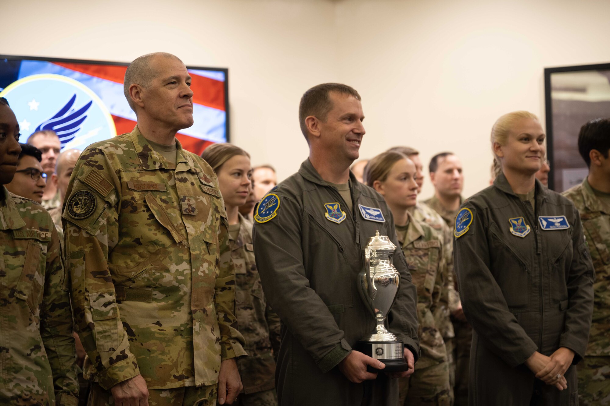 U.S. Air Force Lt. Gen. Thomas Bussiere, United States Strategic Command deputy commander, presents the Omaha Trophy to the 509th Operations Support Squadron for excellence in strategic bomber execution Aug. 4, 2022, on Whiteman Air Force Base, Mo. The Omaha Trophy is an annual award given to the best units in four different categories across the United States Strategic Command. (U.S. Air Force photo by Airman 1st Class Bryson Britt)