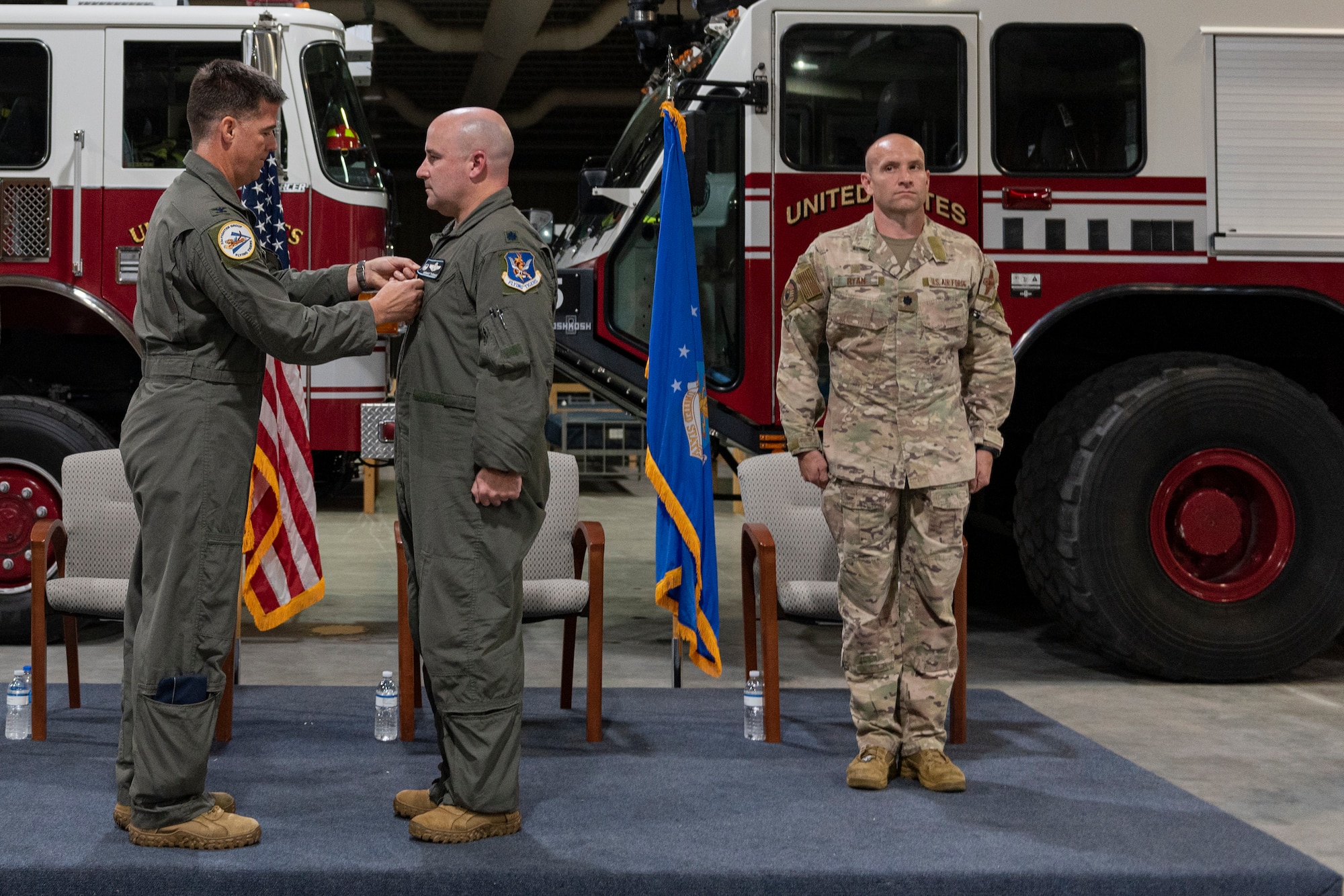 Photo of an Airman pinning a meritorious service medal on another Airman