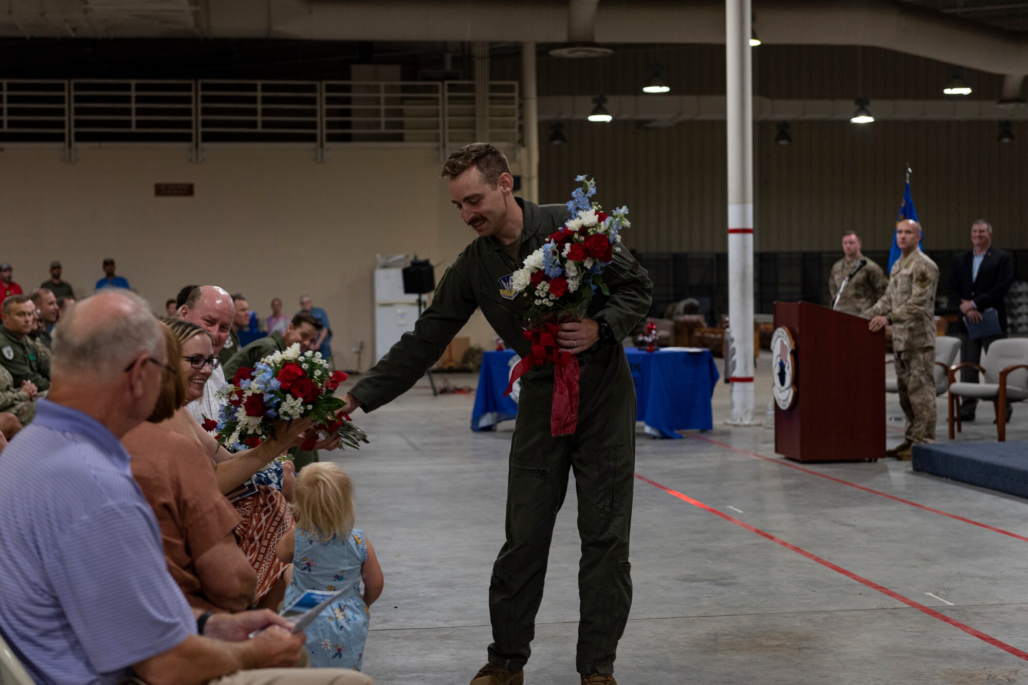 Photo of an Airman's wife receiving flowers