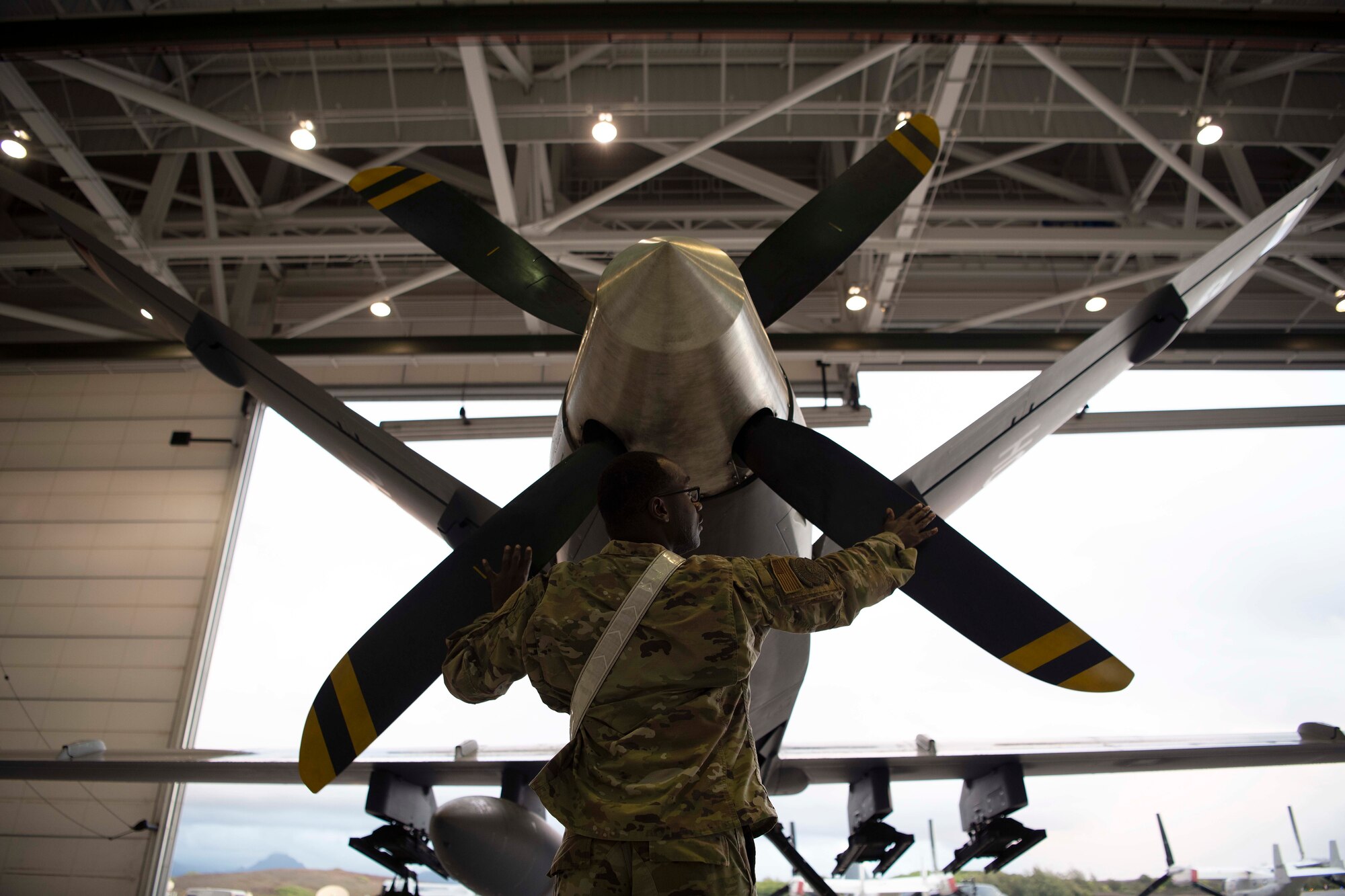 MARINE CORPS AIR STATION, KANEOHE BAY, Hawaii (July 25, 2022) U.S. Air Force Senior Airman Dwain Tribble, 49th Aircraft Maintenance Squadron weapons load crew member, inspects an MQ-9 Reaper tail during Rim of the Pacific (RIMPAC) 2022, July 25, at Marine Corps Air Station Kaneohe Bay, Hawaii.