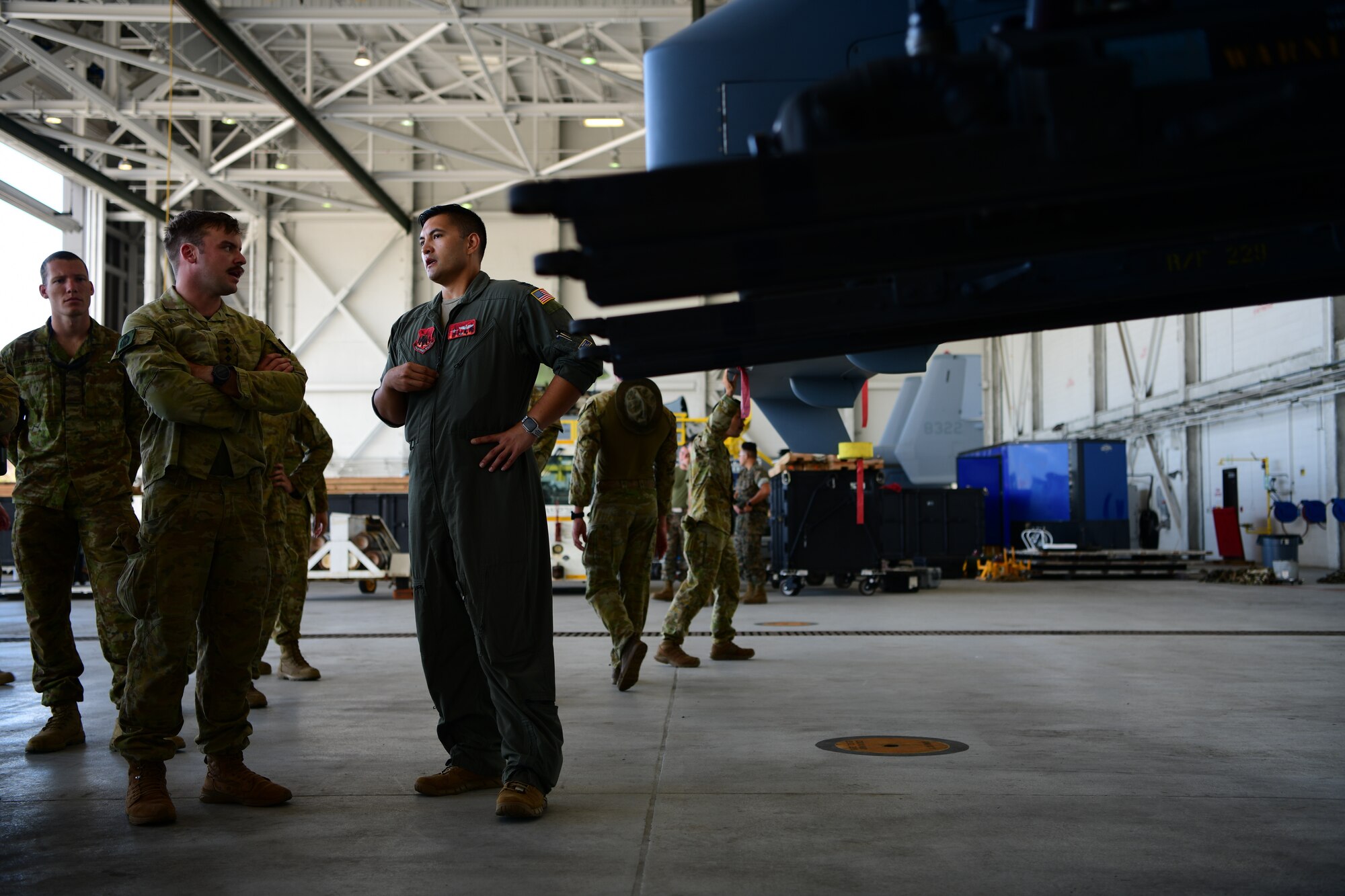 MARINE CORPS AIR STATION KANEOHE BAY, Hawaii (July 28, 2022) U.S. Air National Guard Capt. Phillip West, Rim of the Pacific (RIMPAC) 2022 MQ-9 maritime force integration lead, gives an MQ-9 familiarization brief to members of the Royal Australian Army and the New Zealand Army during RIMPAC 2022, July 28, at Marine Corps Air Station Kaneohe Bay, Hawaii.