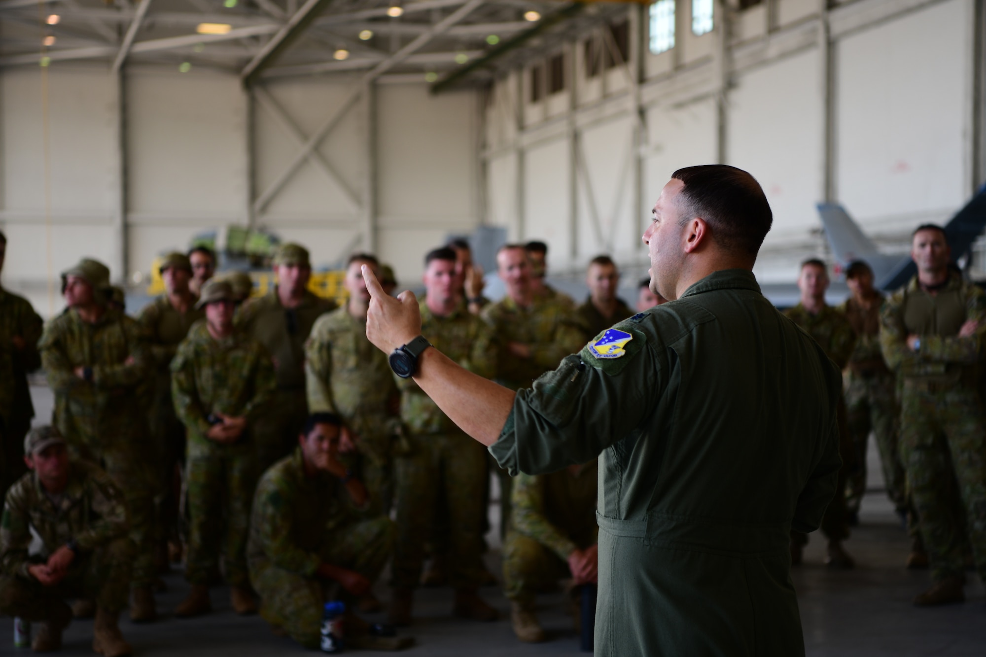 MARINE CORPS AIR STATION KANEOHE BAY, Hawaii (July 28, 2022) U.S. Air Force Lt. Col. Justin Muller, Rim of the Pacific (RIMPAC) 2022 MQ-9 Reaper detachment lead, explains MQ-9 operations and specifications to members of the Royal Australian Army and the New Zealand Army during Rim of the Pacific (RIMPAC) 2022, July 28, at Marine Corps Air Station Kaneohe Bay, Hawaii.