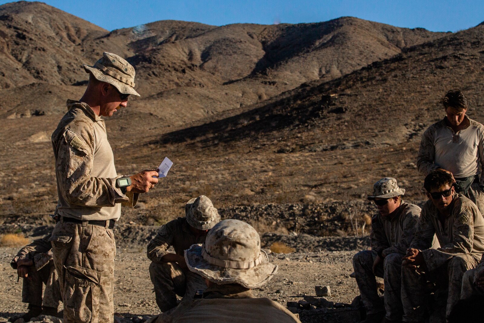 A U.S. Marine Corps Gunnery Sgt. briefs Marines during a rehearsal of concept drill.