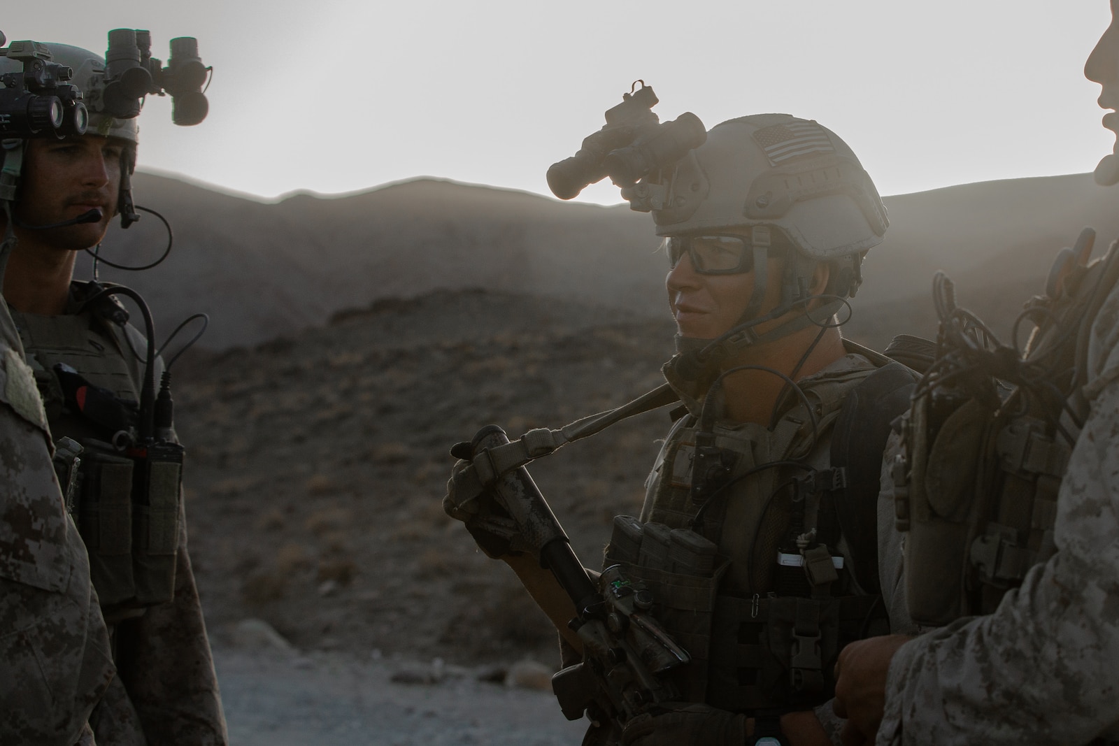 A U.S. Marine checks his team’s gear before a night hike.