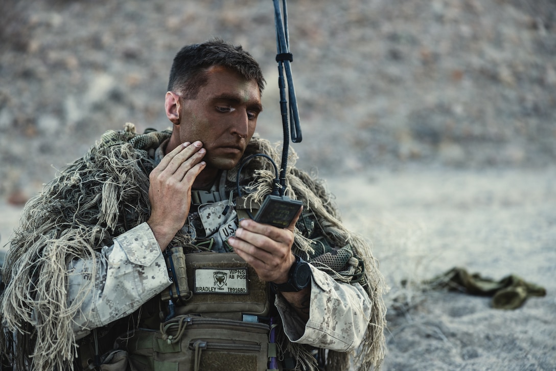 U.S. Marine Corps  chief scout sniper applies camouflage face paint