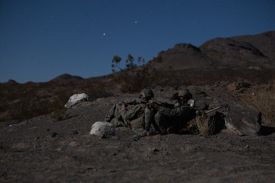 U.S. Marines with 1st Battalion, 6th Marine Regiment, 2nd Marine Division, halt and provide security while patrolling during the non-live fire training for the Ground Reconnaissance Course at Marine Corps Air Ground Combat Center, Twentynine Palms, California, May 16, 2022. During the course, Marines were tasked with patrolling and observing live role players’ positions and movements undetected. (U.S. Marine Corps photo by Lance Cpl. Andrew R. Bray)