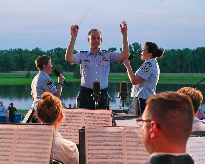 U.S. Air Force 1st Lt. Brandon Holtz, flight commander and associate conductor of the U.S. Air Force Concert Band, conducts the band at Mt. Vernon, Ill., July 4, 2022. This concert was part of the first tour the band performed in over two and a half years since the COVID restrictions were implemented. (U.S. Air Force photo by Airman Bill Guilliam)