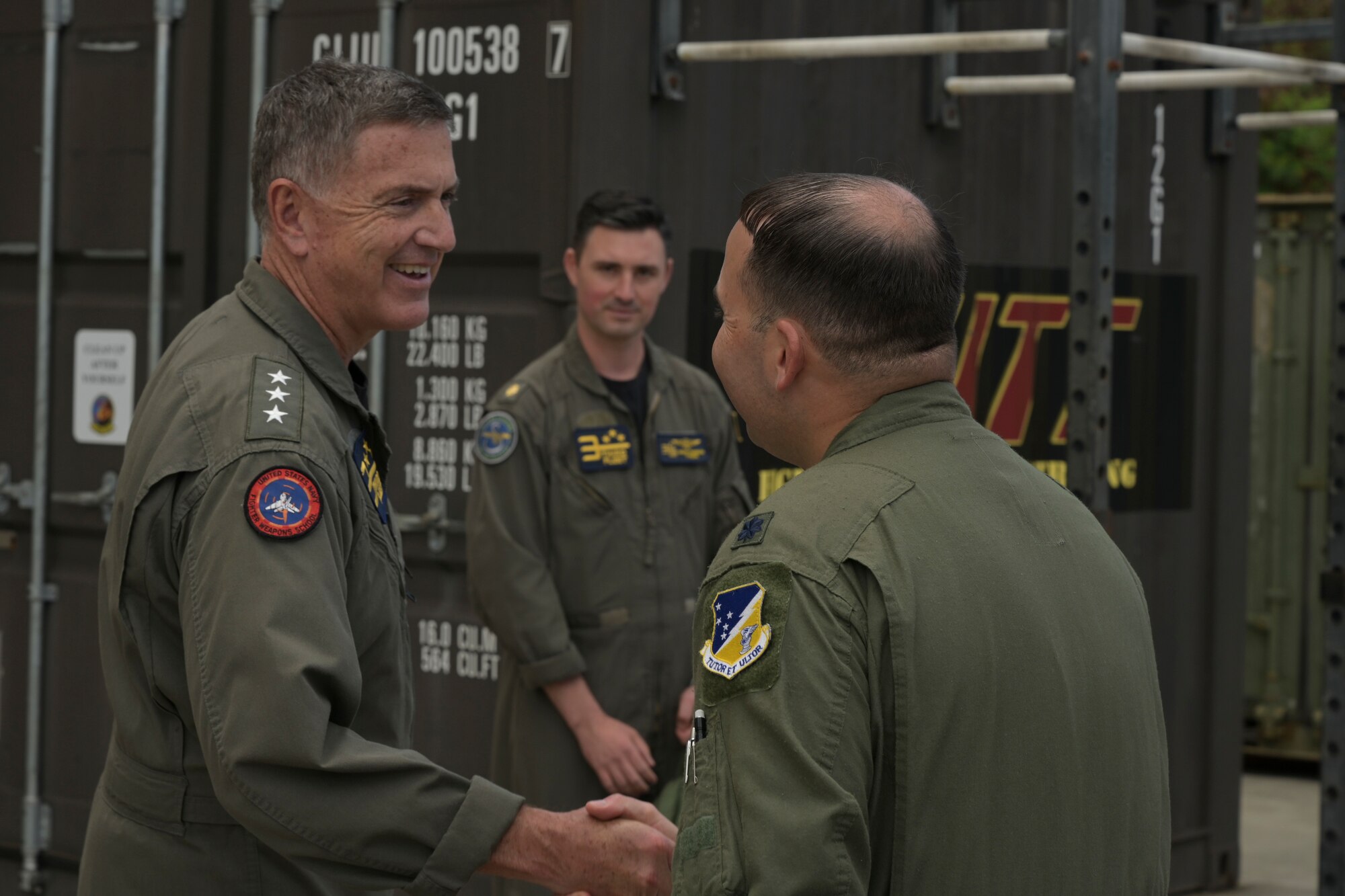 KANEOHE BAY, Hawaii (July 28, 2022) U.S. Navy Vice Adm. Michael E. Boyle, Commander, 3rd Fleet, and U.S. Air Force Lt. Col. Justin Muller, Rim of the Pacific (RIMPAC) 2022 MQ-9 detachment mission commander, shake hands as Boyle departs the MQ-9 operations center during RIMPAC, July 29, at Marine Corps Air Station Kaneohe Bay, Hawaii.