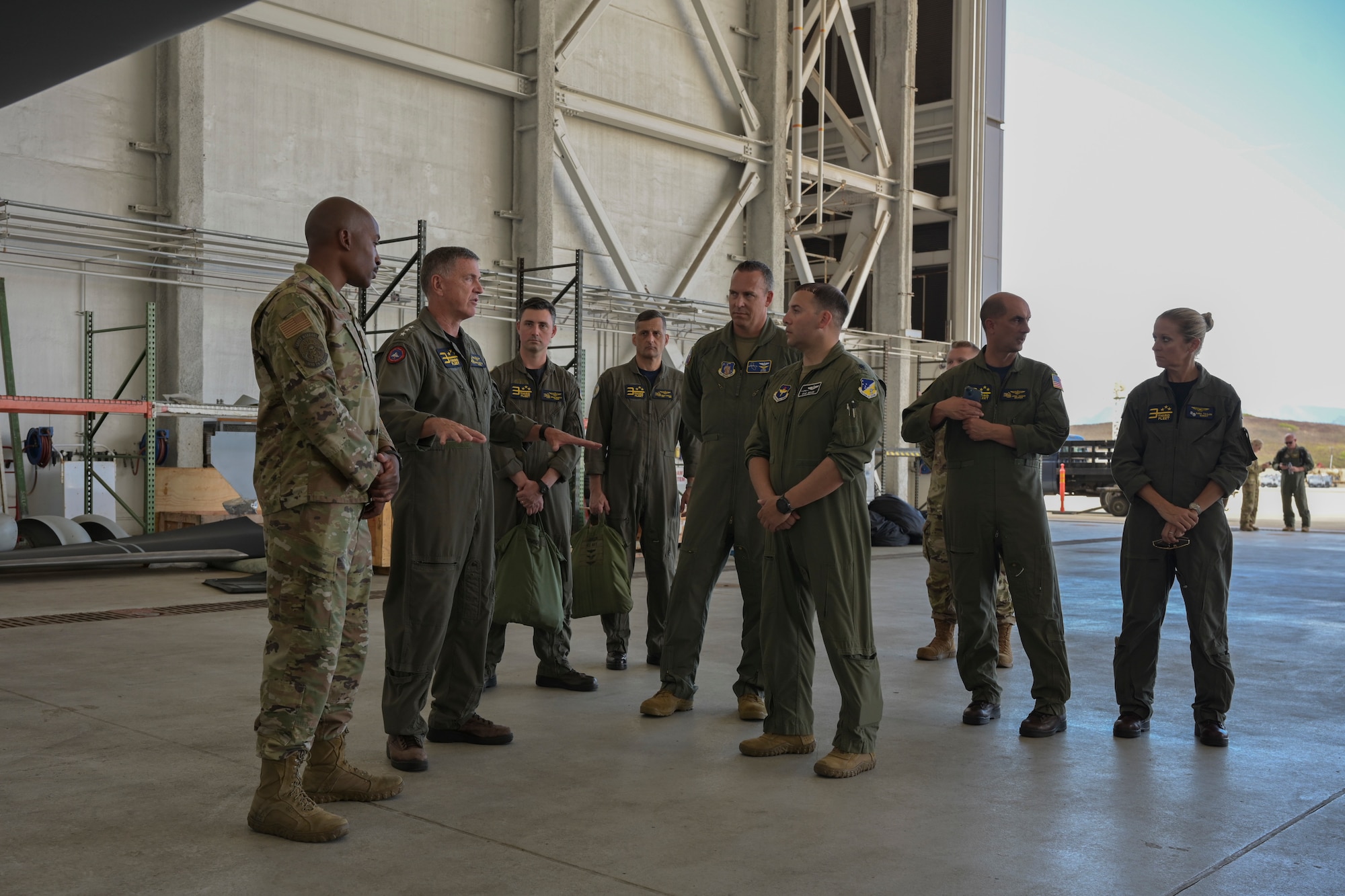 KANEOHE BAY, Hawaii (July 28, 2022) U.S. Air Force Lt. Col. Justin Muller, Rim of the Pacific (RIMPAC) 2022 MQ-9 detachment mission commander, and U.S. Air Force Master Sgt. Terrelle Thomas, 29th Aircraft Maintenance Squadron production superintendent, explain general MQ-9 Reaper specifications and maintenance procedures to U.S. Navy Vice Adm. Michael E. Boyle, Commander, 3rd Fleet, during RIMPAC, July 29, at Marine Corps Air Station Kaneohe Bay, Hawaii.