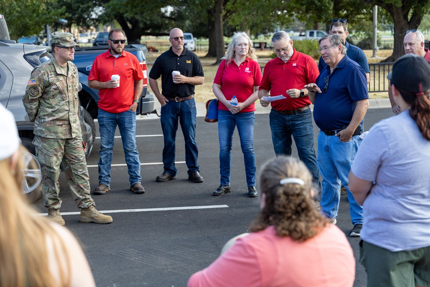 a group of people in a parking lot talking