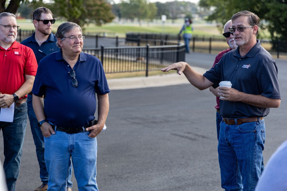 a group of people in a parking lot talking