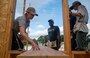 Lt.j.g. Caitlyn Bezecny, attached to Ticonderoga-class guided missile cruiser USS Lake Champlain (CG 57), instructs Sailors on measuring and cutting wood at a Habitat for Humanity community relations event during Fleet Week Seattle, Aug. 4, 2022. Fleet Week Seattle is a time-honored celebration of the sea services and provides an opportunity for the citizens of Washington to meet Sailors, Marines and Coast Guardsmen, as well as witness firsthand the latest capabilities of today's maritime services. (U.S. Navy Photo by Mass Communication Specialist 2nd Class Ethan J. Soto)