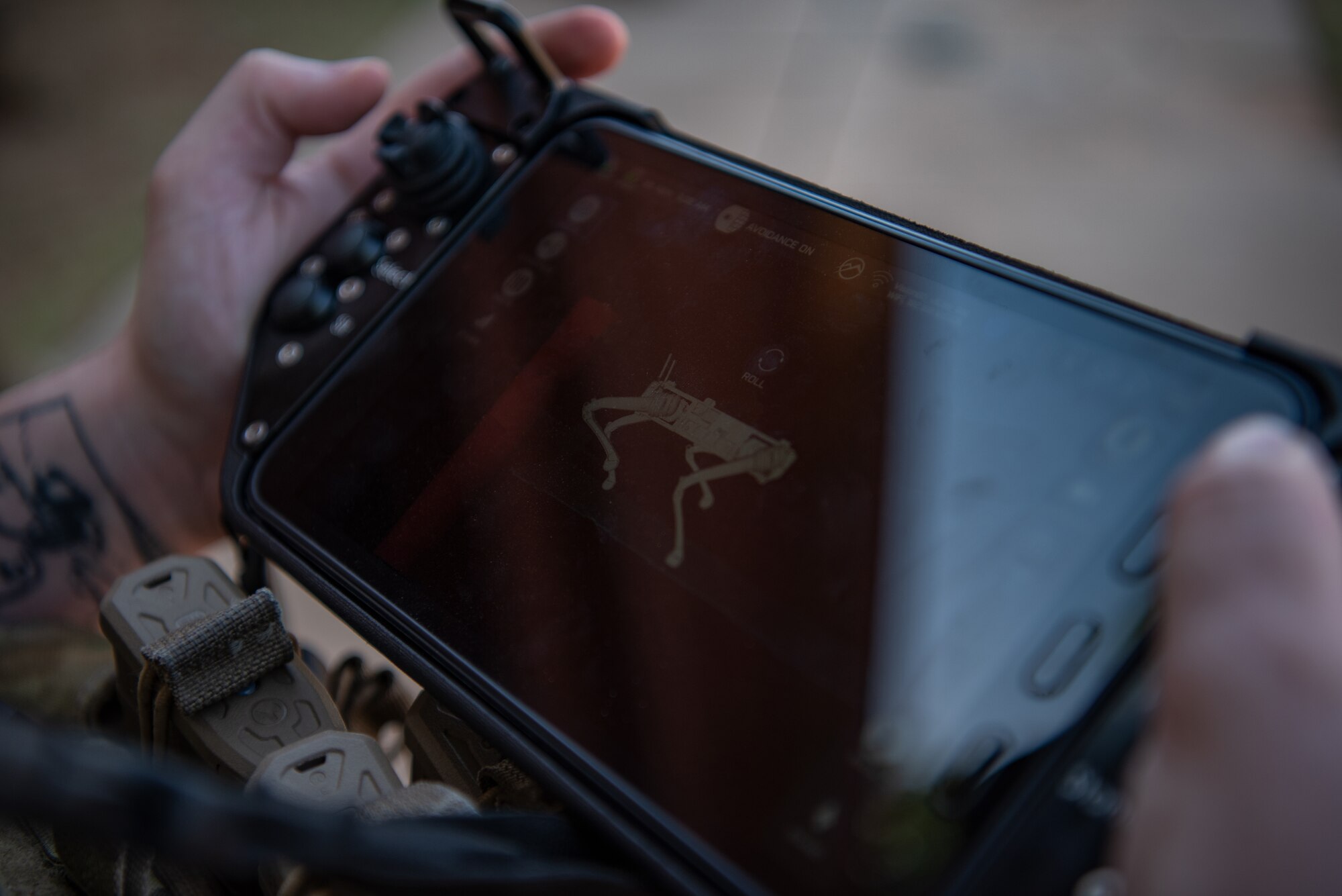 Senior Airman Sullivan Clinton, 7th Security Forces Squadron patrolman, operates a robot dog controller at Dyess Air Force Base, Texas, Aug. 5, 2022. The addition of robot dogs are expected to bolster base defense and provide early warning detection of potential threats. (U.S. Air Force photo by Airman 1st Class Ryan Hayman)