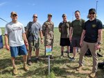 Six men stand and pose for a photo