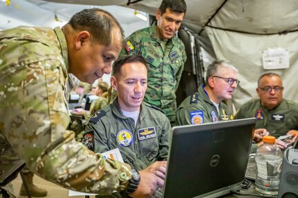 Military service members from Ecuador and Peru talk during PANAMAX 2022 on Joint Base San Antonio-Fort Sam Houston, August 4, 2022. PANAMAX 2022, a U.S. Southern Command-sponsored multinational command post exercise aimed at reinforcing and enhancing the long-term security of the Panama Canal and the Western Hemisphere, took place August 1-12, at bases in Texas, Florida, Virginia and Arizona. (U.S. Army photo by Spc. Joshua Taeckens)