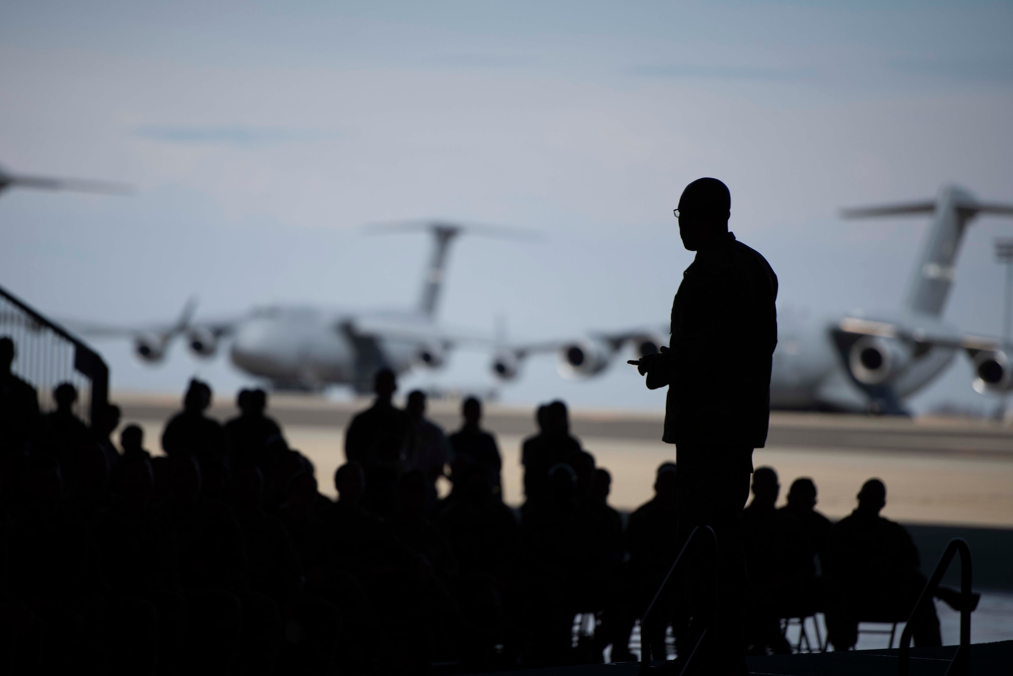 The silhouette of CSAF Gen. CQ Brown, Jr., speaking to Airmen