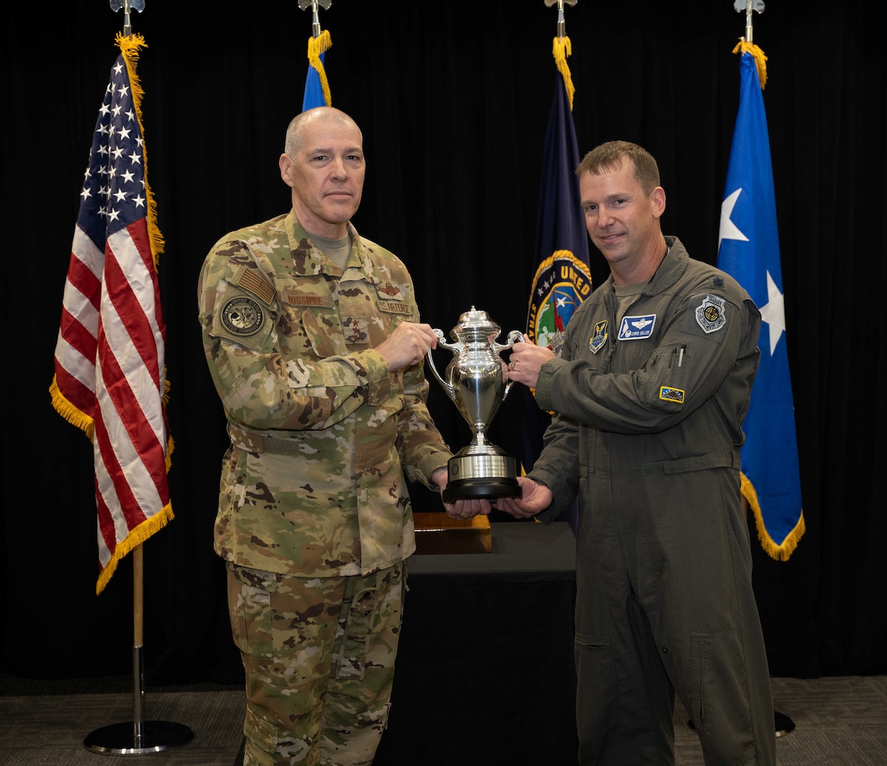 U.S. Air Force Lt. Gen. Thomas Bussiere, United States Strategic Command deputy commander, presents the Omaha Trophy to the 509th Operations Support Squadron for excellence in strategic bomber execution Aug. 4, 2022, on Whiteman Air Force Base, Mo. The Omaha Trophy is an annual award given to the best units in four different categories across the United States Strategic Command. (U.S. Air Force photo by Airman 1st Class Bryson Britt)
