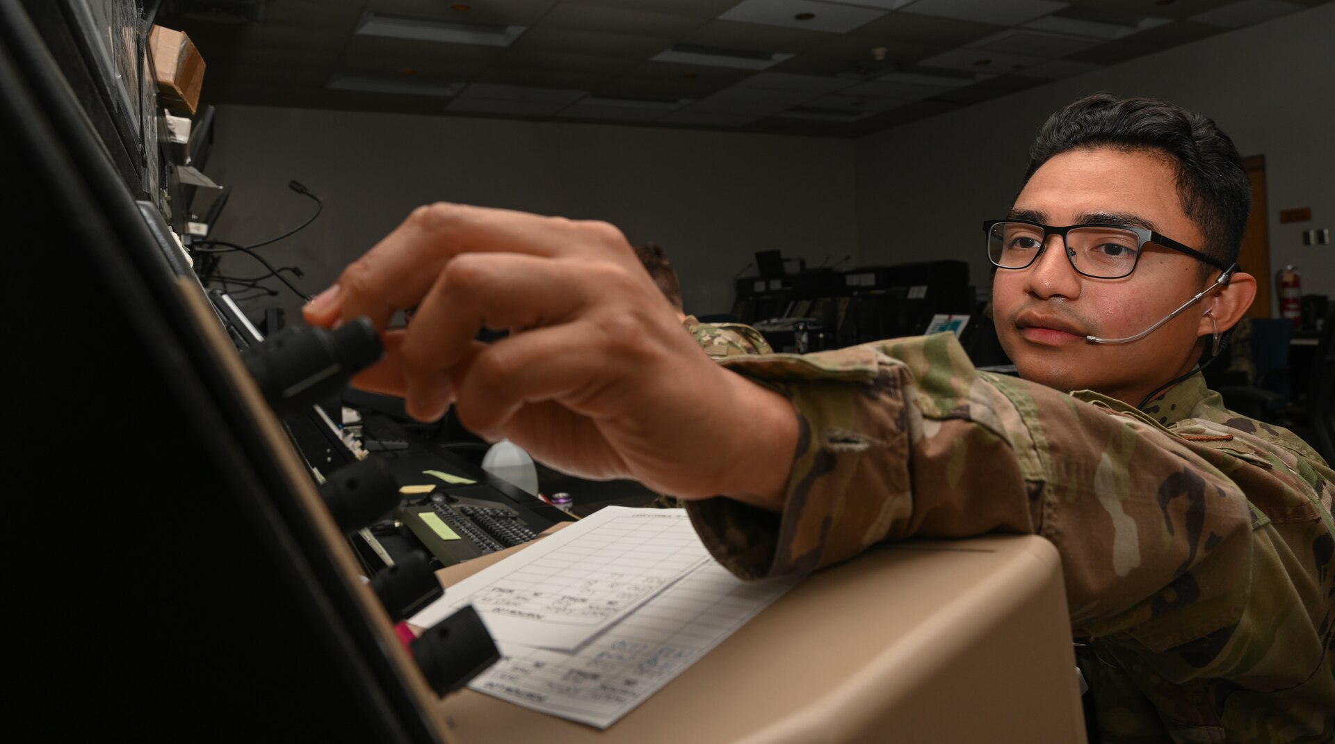 U.S. Air Force Senior Airman Gabriel Leon, a 509th Operations Support Squadron air traffic controller journeymen, poses for a photo in the Radar Approach Control Center on Whiteman Air Force Base May 25, 2022. Air traffic controller are responsible for managing the flow of aircraft through all aspects of their flight. (U.S. Air Force by Airman 1st Class Bryson Britt)