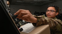 U.S. Air Force Senior Airman Gabriel Leon, a 509th Operations Support Squadron air traffic controller journeymen, poses for a photo in the Radar Approach Control Center on Whiteman Air Force Base May 25, 2022. Air traffic controller are responsible for managing the flow of aircraft through all aspects of their flight. (U.S. Air Force by Airman 1st Class Bryson Britt)
