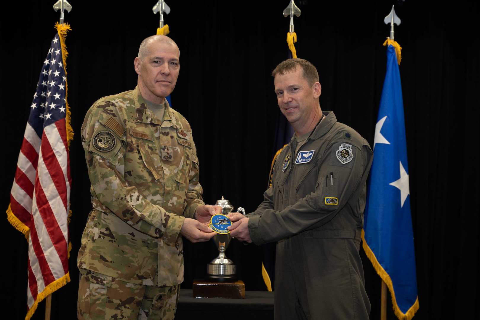 U.S. Air Force Lt. Gen. Thomas Bussiere, United States Strategic Command deputy commander, presents the Omaha Trophy to the 509th Operations Support Squadron for excellence in strategic bomber execution Aug. 4, 2022, on Whiteman Air Force Base, Mo. The Omaha Trophy is an annual award given to the best units in four different categories across the United States Strategic Command. (U.S. Air Force photo by Airman 1st Class Bryson Britt)