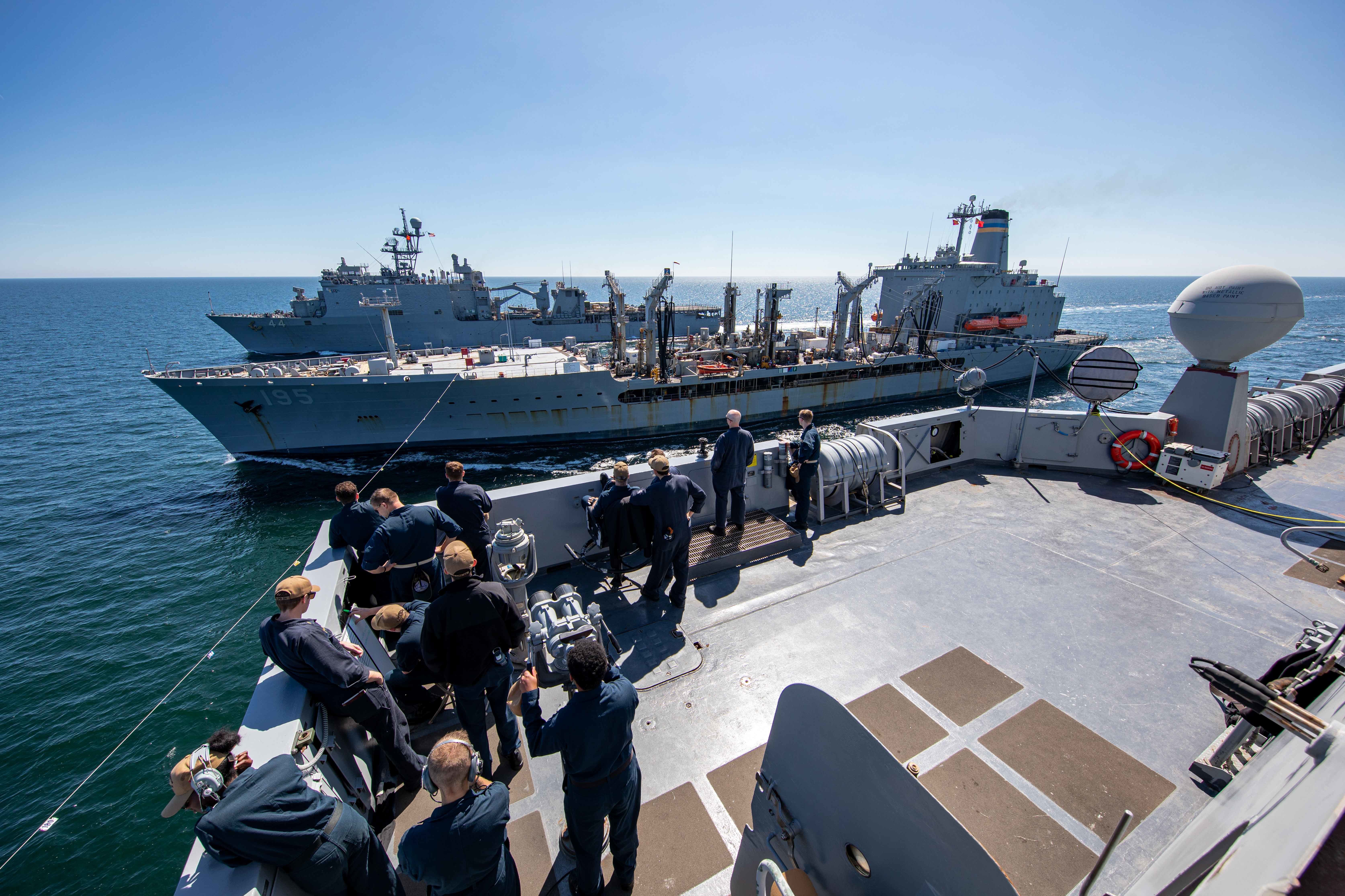USS Arlington (LPD 24), foreground, and USS Gunston Hall (LSD 44) replenish from USNS Leroy Grumman (T-AO 195), middle, in the Baltic Sea.