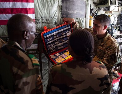 U.S. Air Force Senior Master Sgt. Matthew Monjes, 109th Aeromedical Evacuation Squadron, shows members of the Nigerien armed forces the medication which they could us during a flight in St. Paul, Minn., July 26, 2022.