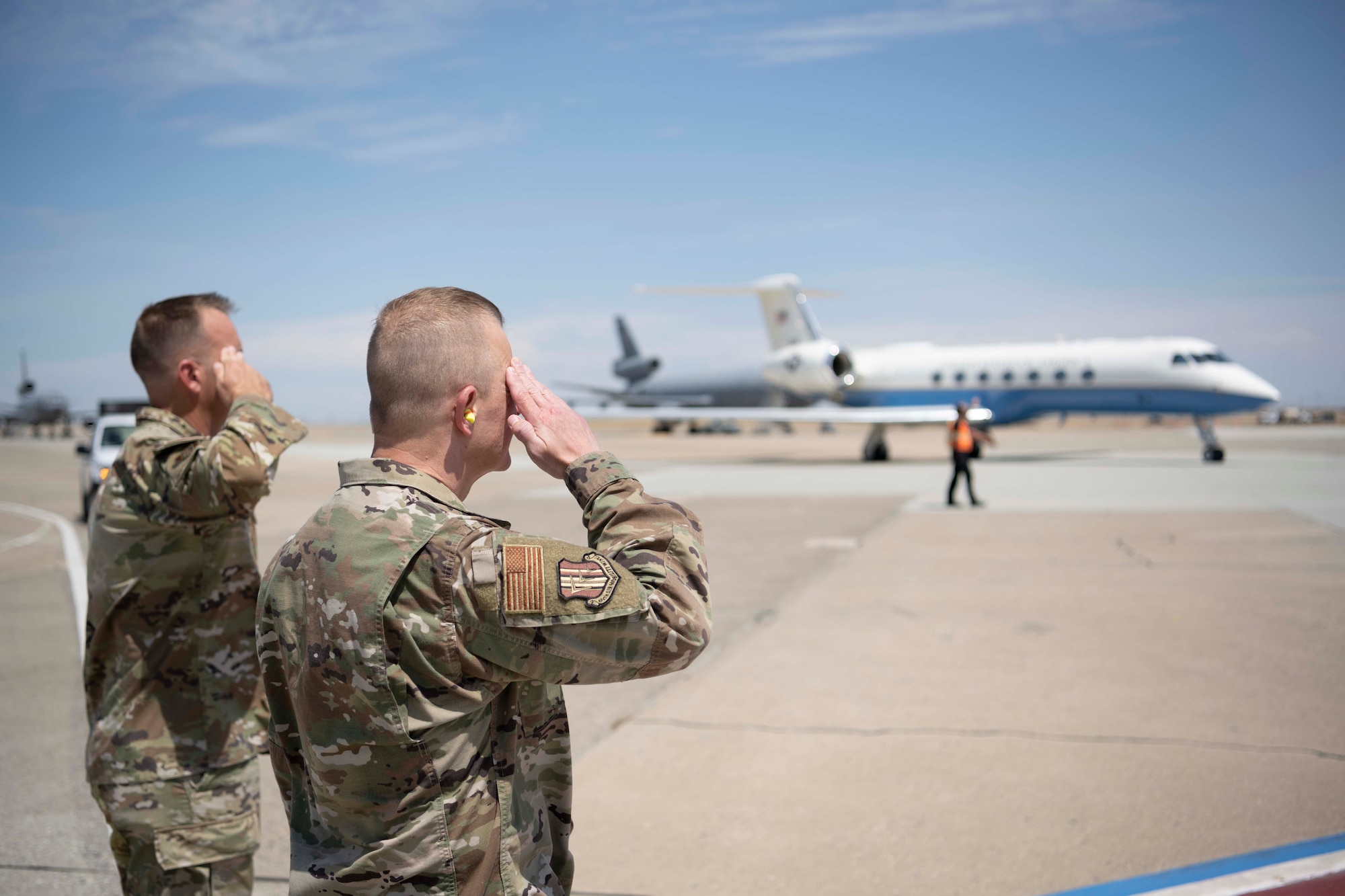Travis AFB leadership salute a plane