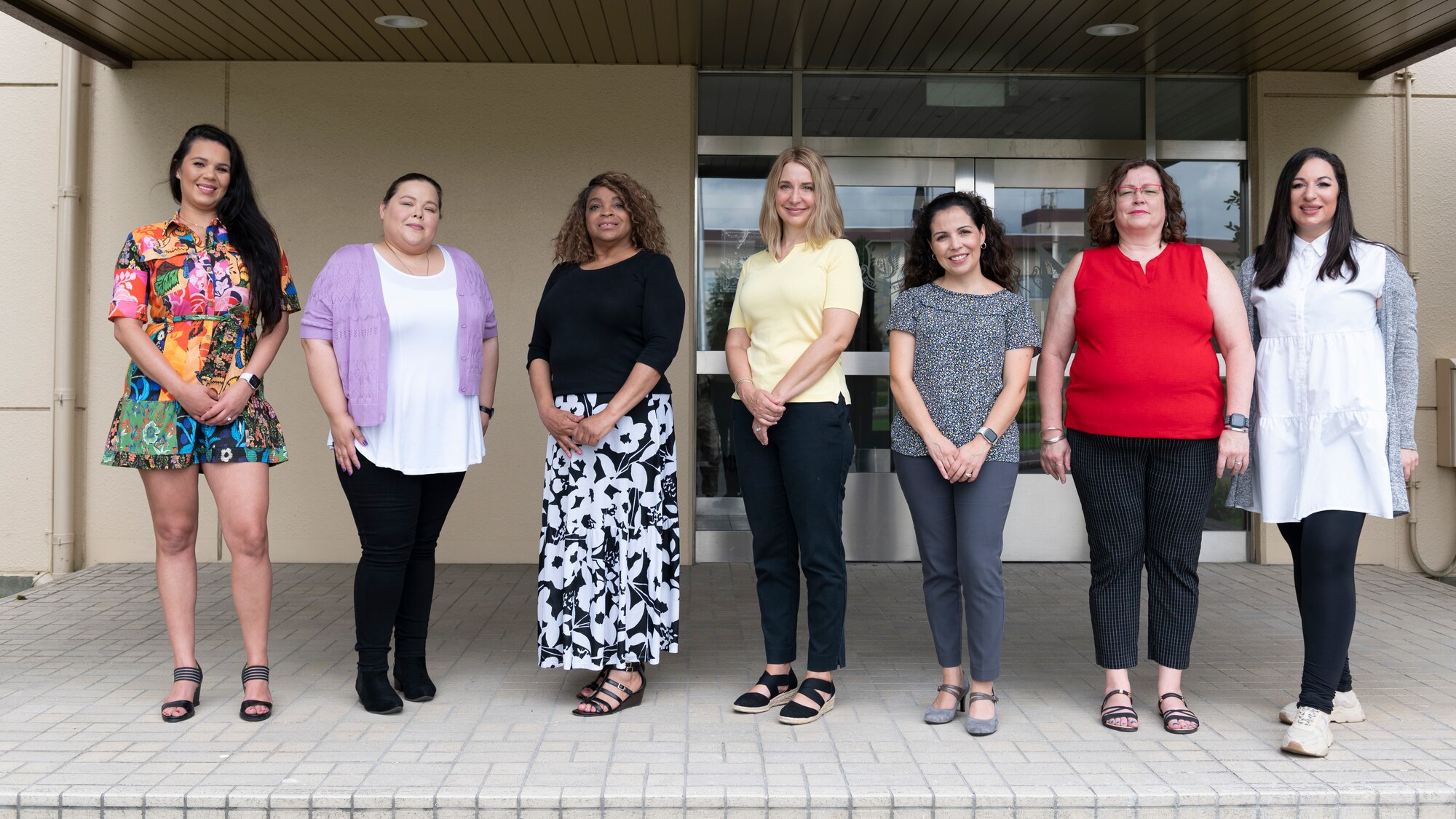 Seven women standing in a entrance way